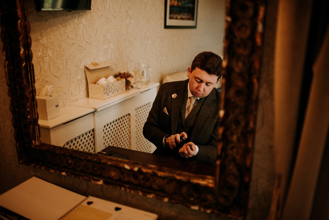 A man standing in front of a mirror posing for the camera