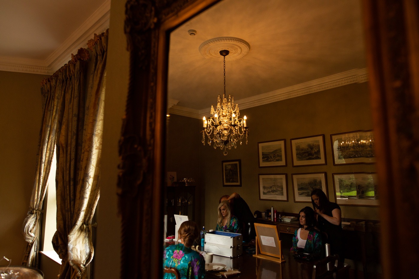 A group of people standing in front of a mirror posing for the camera