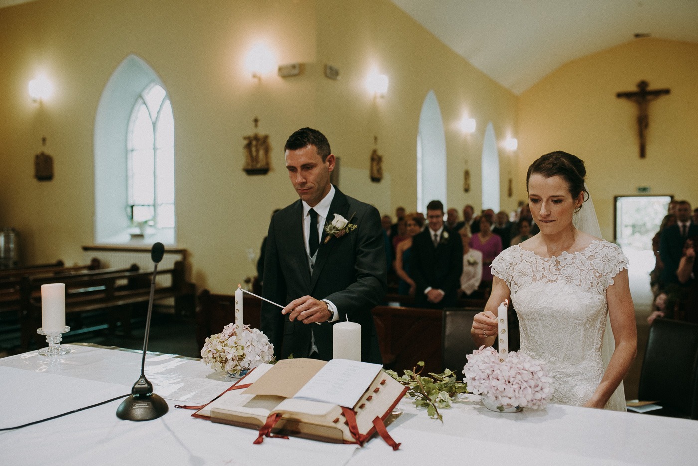 A man and woman cutting a wedding cake