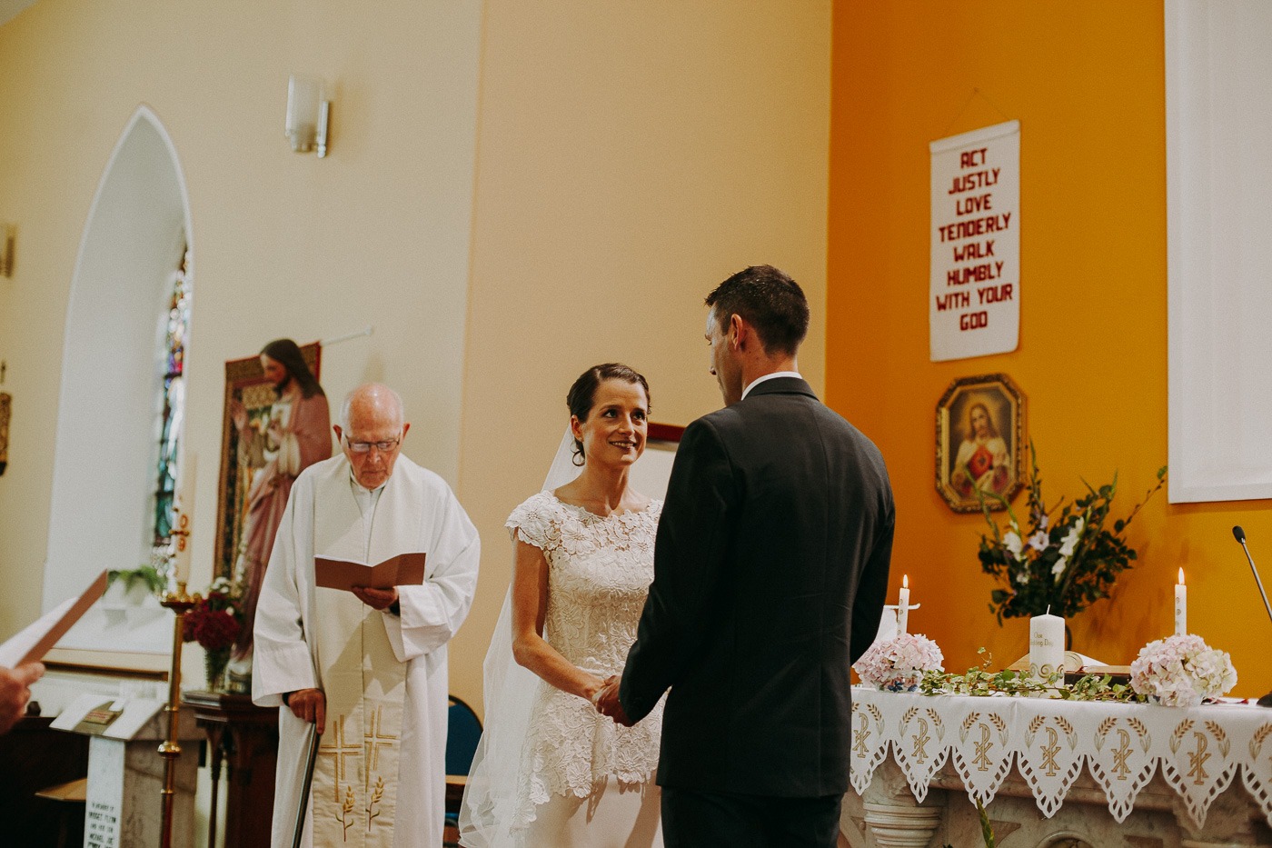 A man and a woman standing in front of a wedding cake