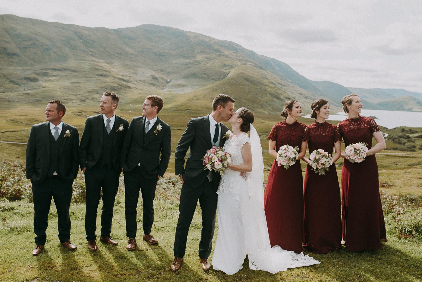 A group of people standing in front of a mountain