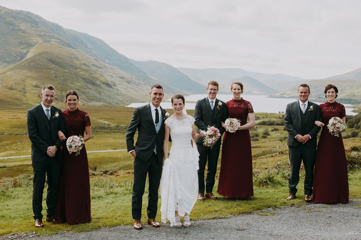 A group of people posing for a photo in front of a mountain