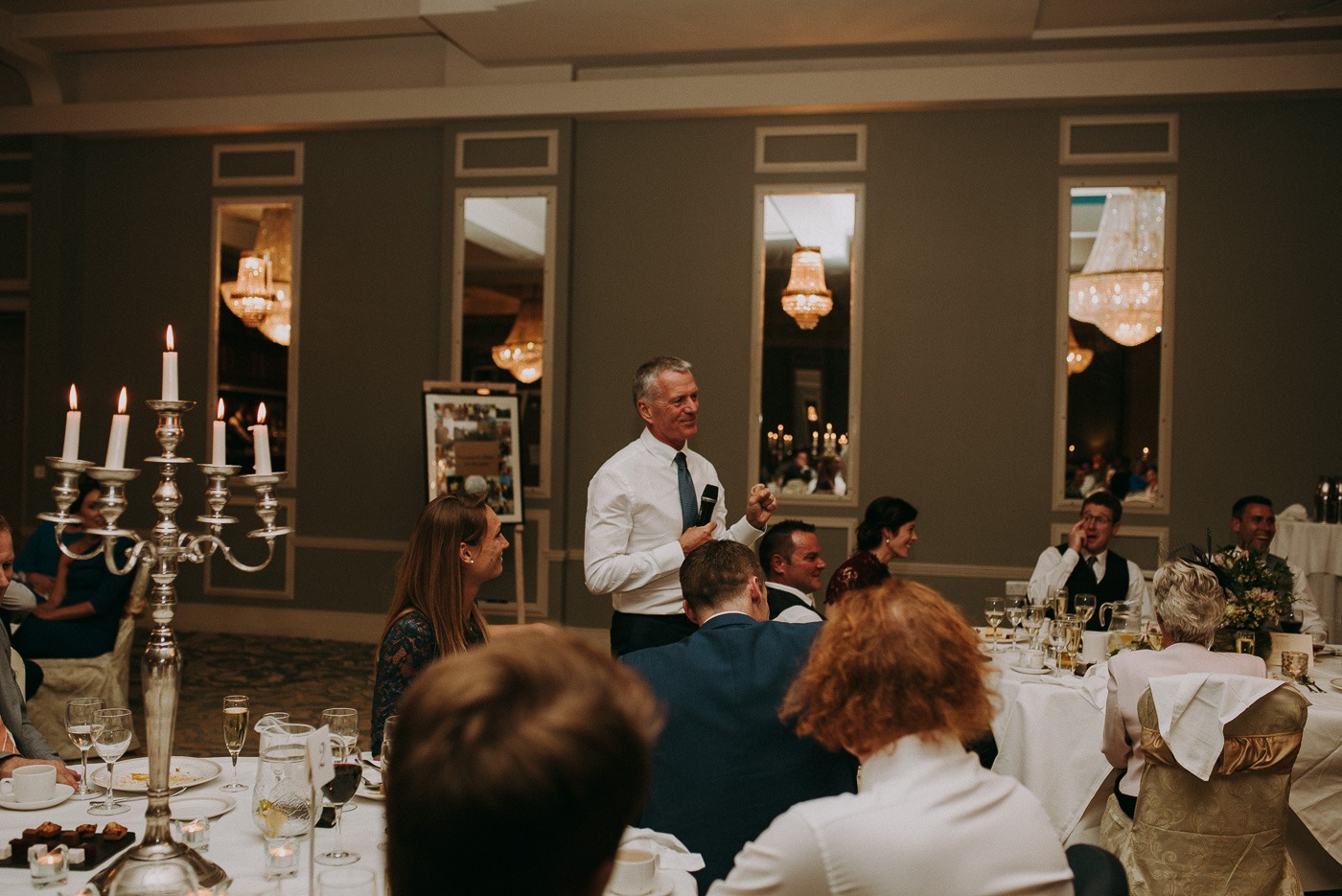 A group of people sitting at a table with wine glasses