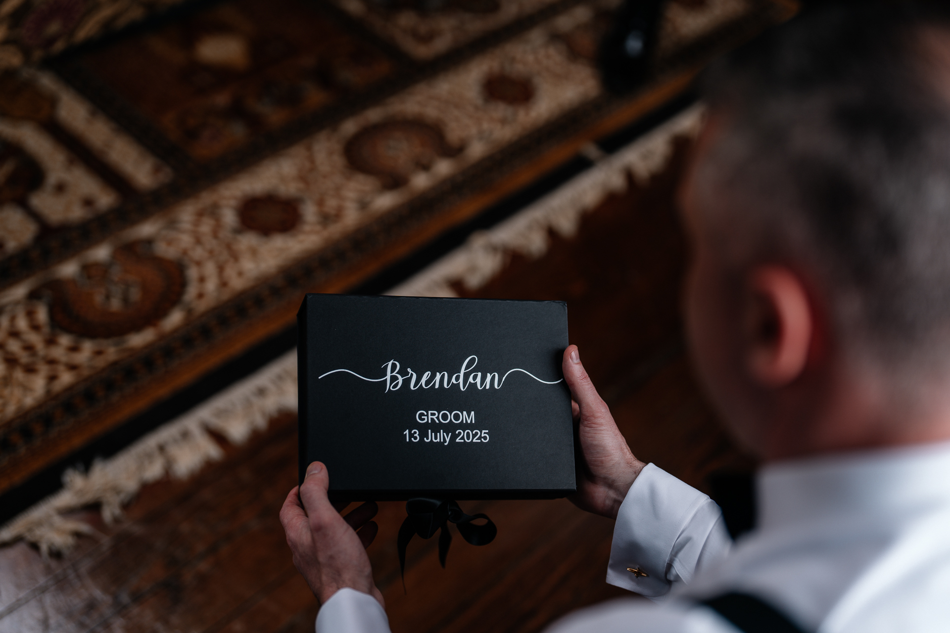 Groom adjusting his bow tie during wedding prep in Billiard Room at Markree Castle