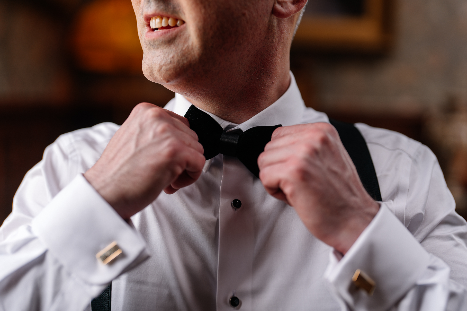 Groom adjusting his bow tie during wedding prep in Billiard Room at Markree Castle