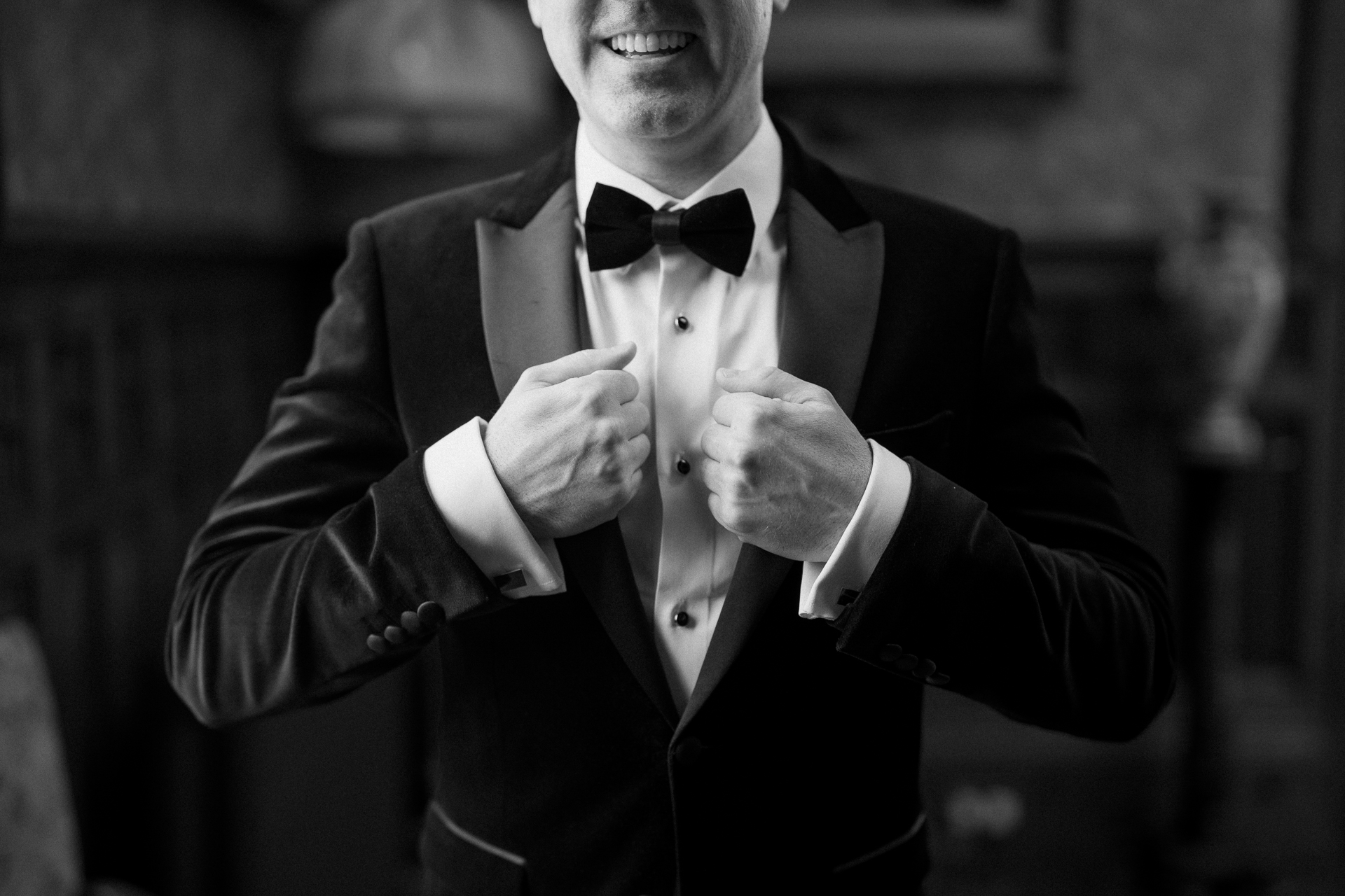 Groom adjusting his bow tie during wedding prep in Billiard Room at Markree Castle