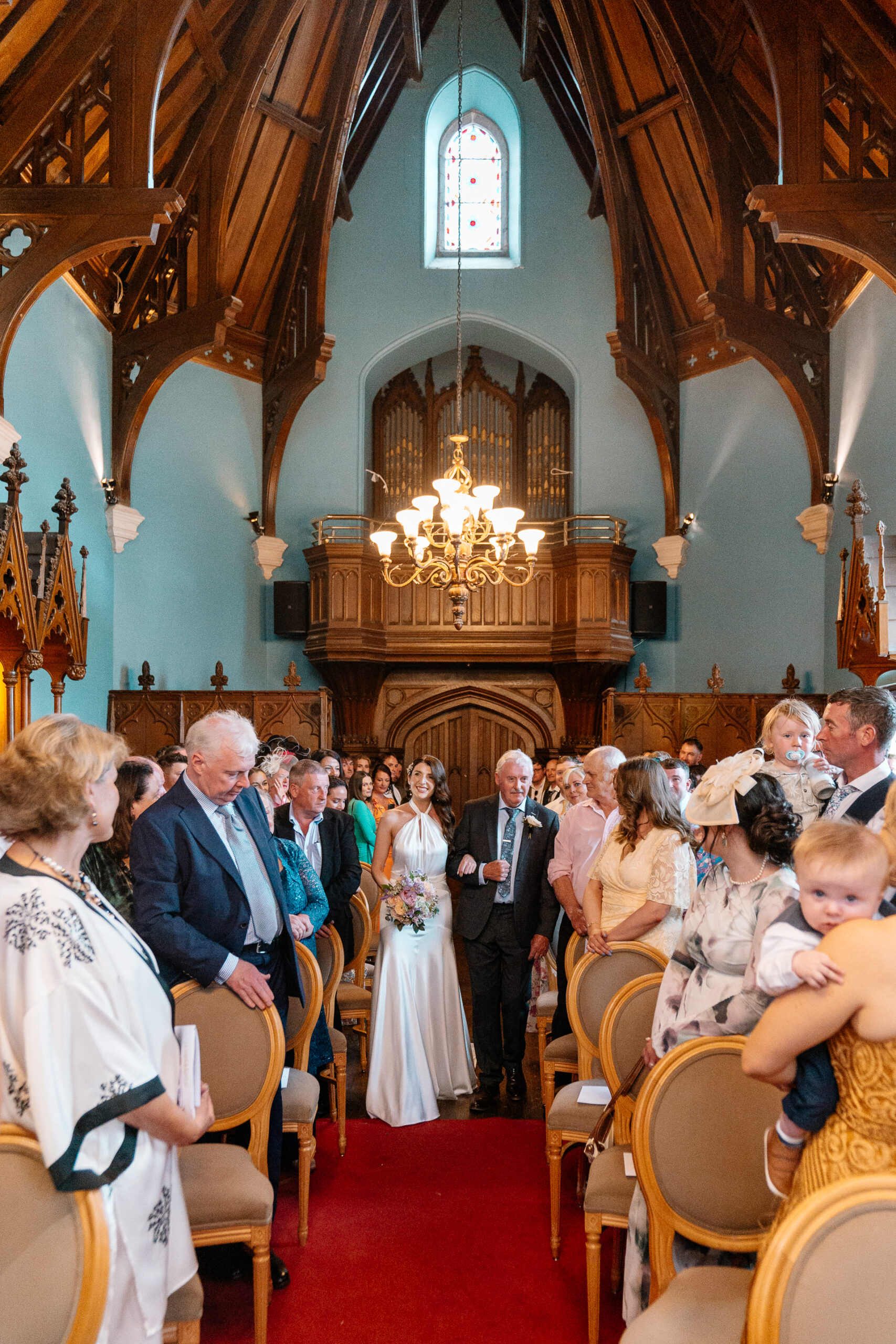 Wedding ceremony in the historic chapel at Markree Castle with natural light and emotional moments