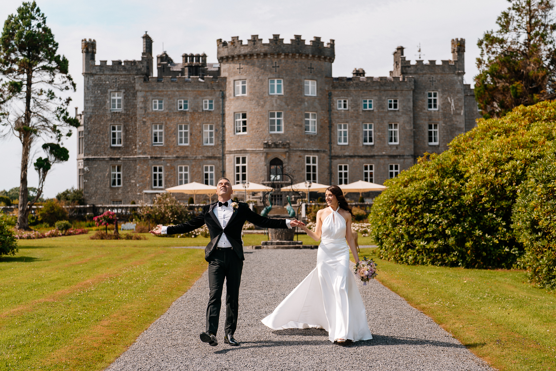 Bride and Groom walking in front of Markree Castle during their wedding day in Sligo, Ireland