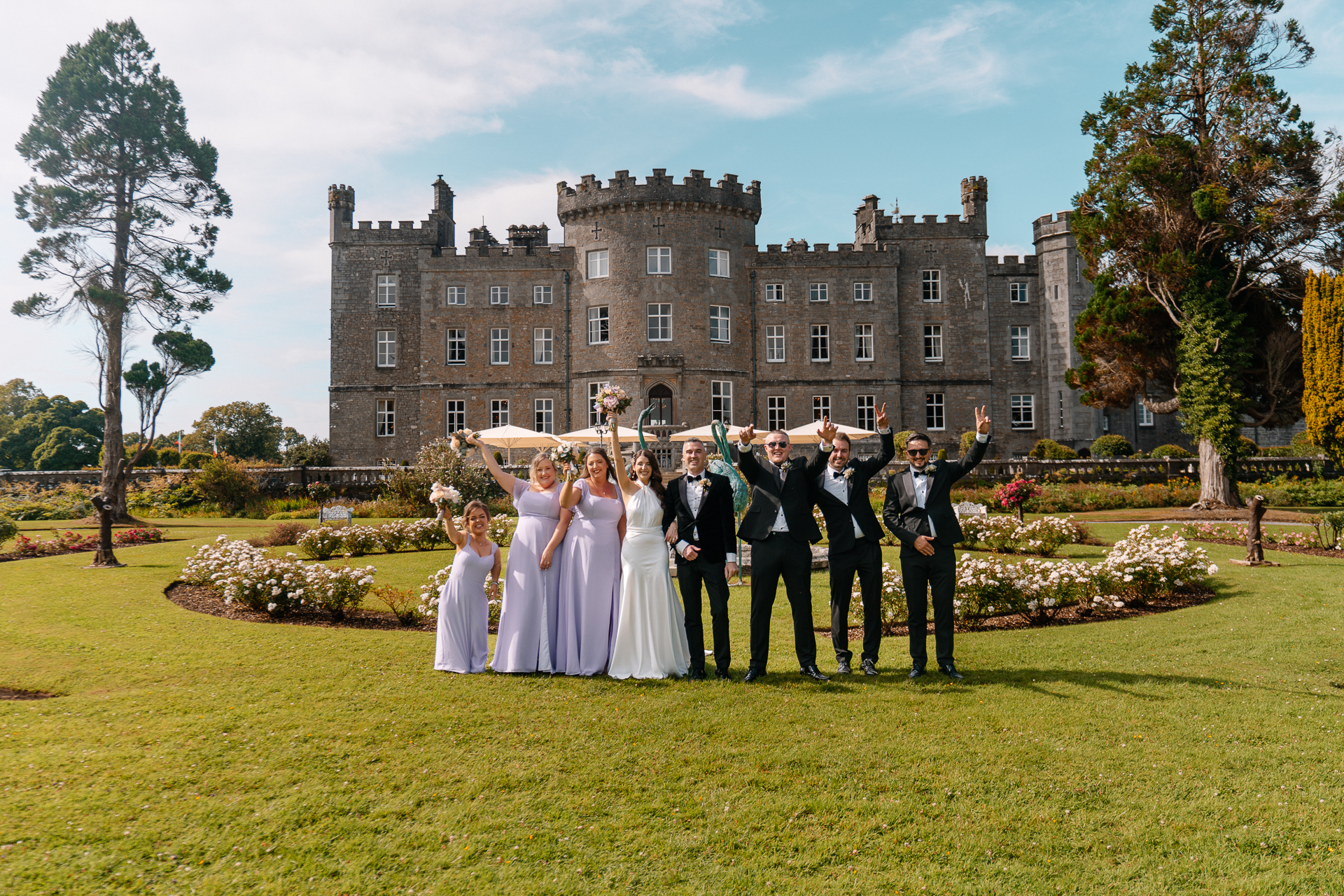 Bridal party celebrating in the garden at Markree Castle during a summer wedding