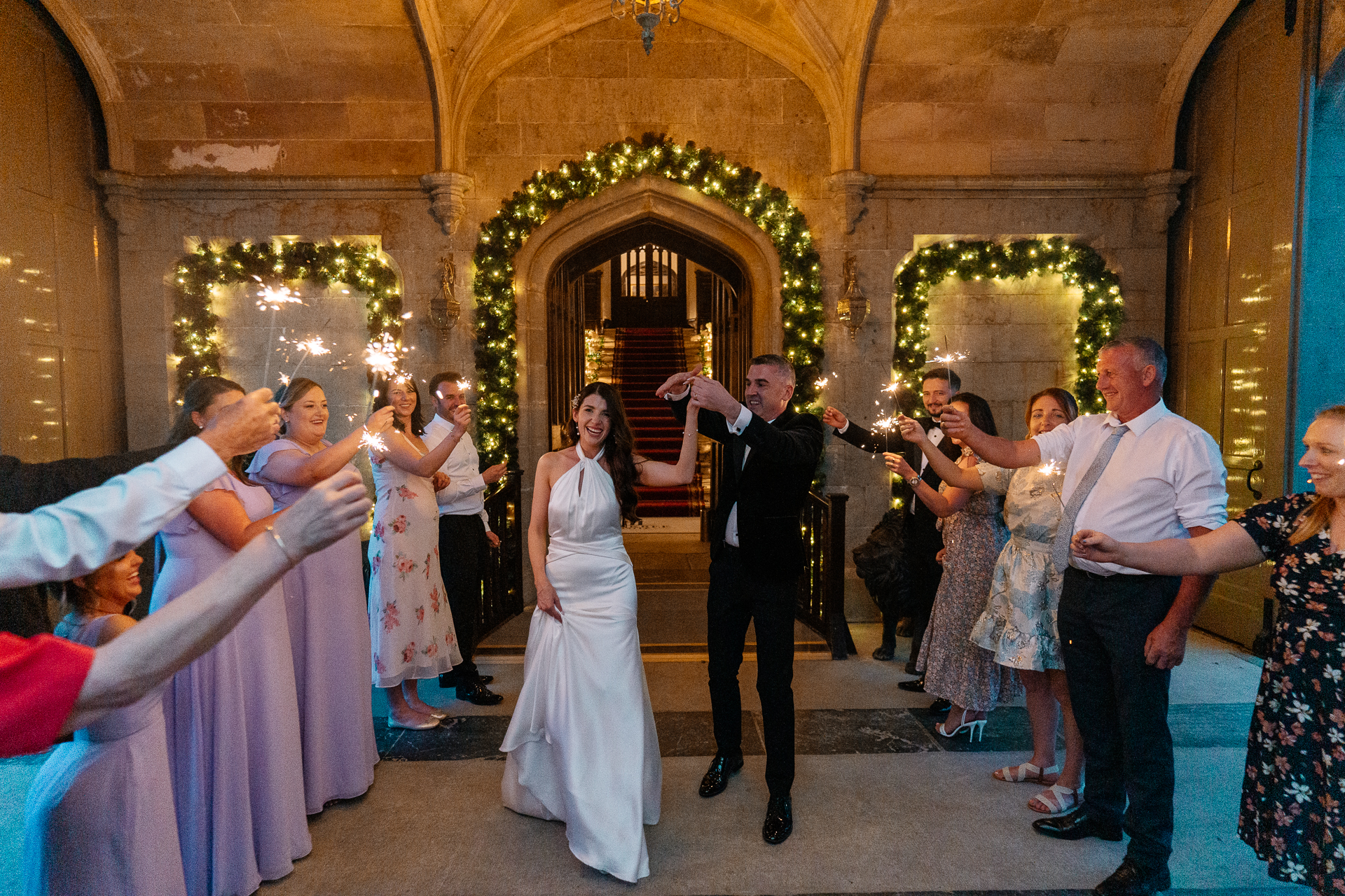 Bride and groom sharing their first dance under the stone archway at the front of Markree Castle