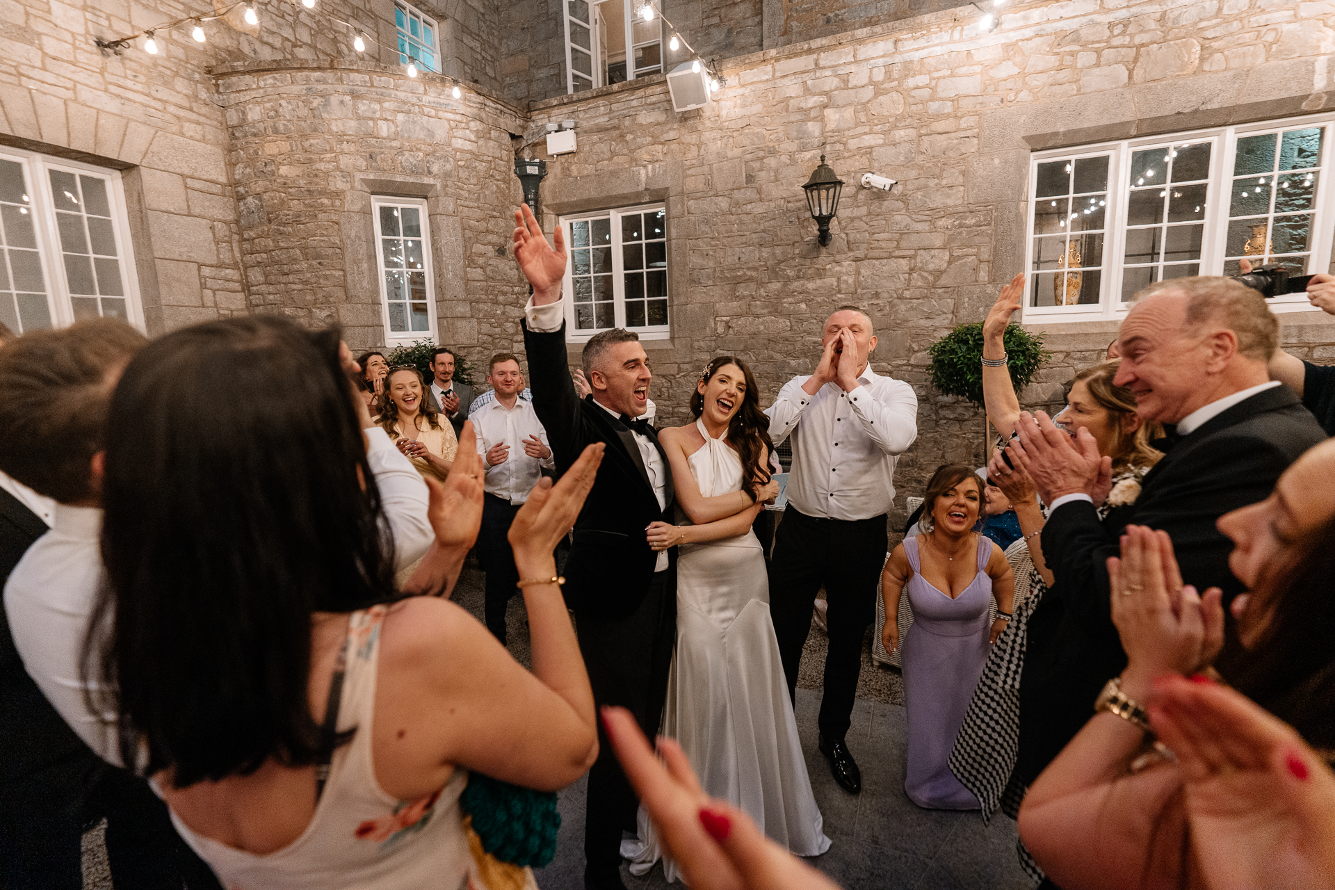 Bride and groom’s first dance under string lights in the Courtyard of Markree Castle
