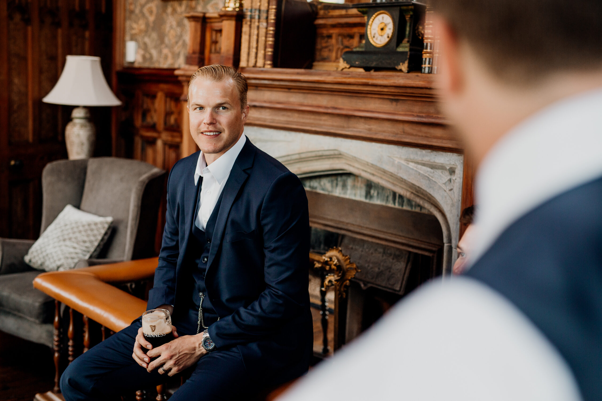 A person in a suit sitting in a chair