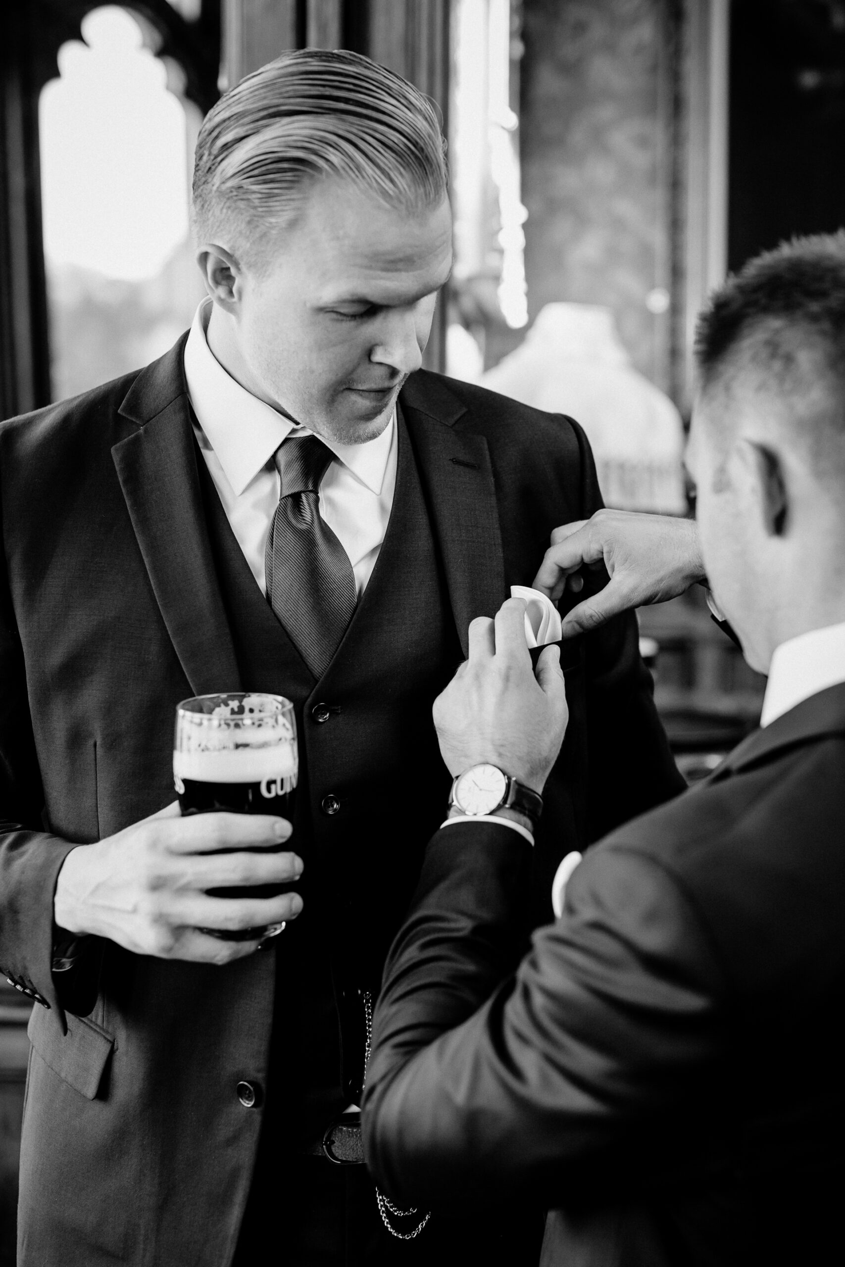 A person in a suit holding a cup of coffee