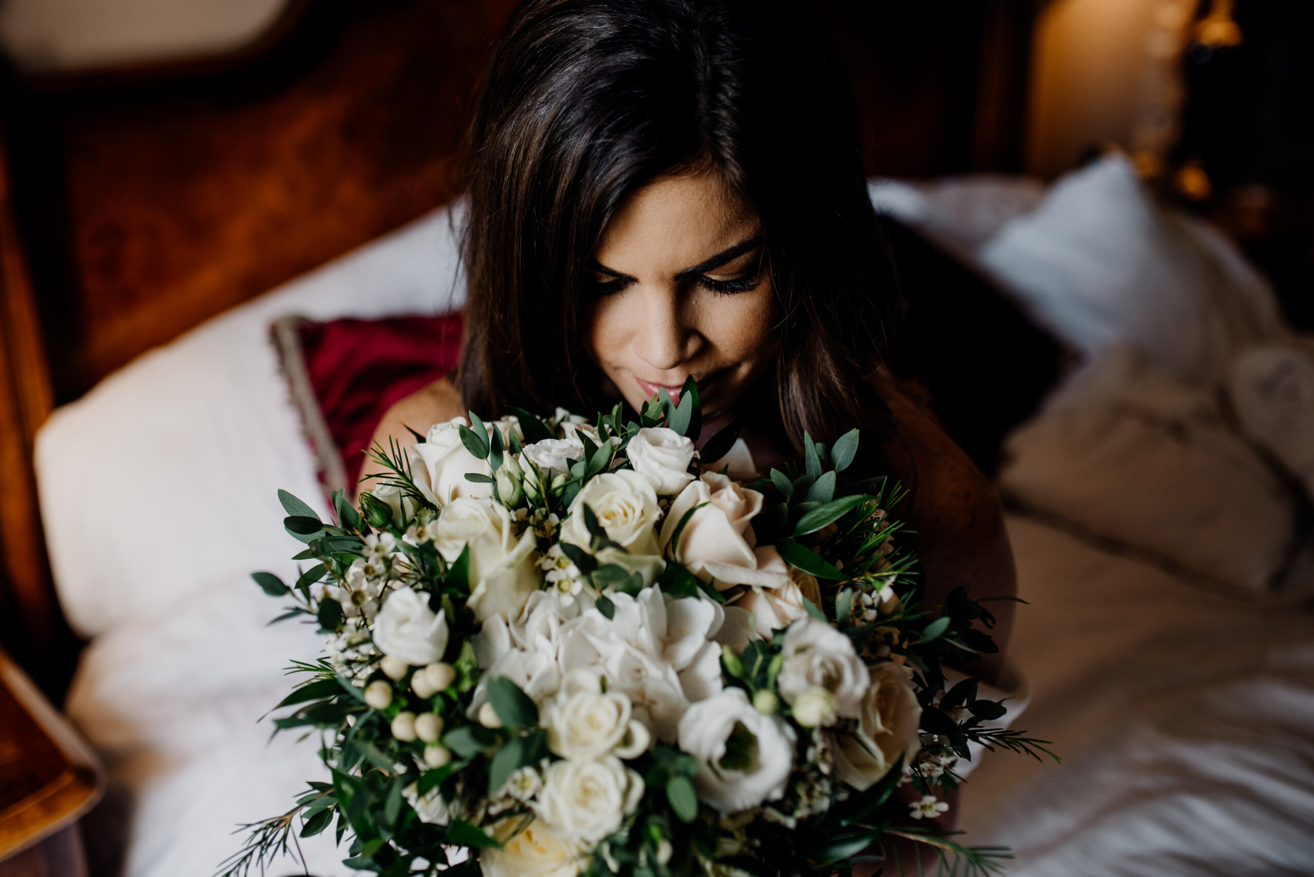 A person holding a bouquet of white flowers