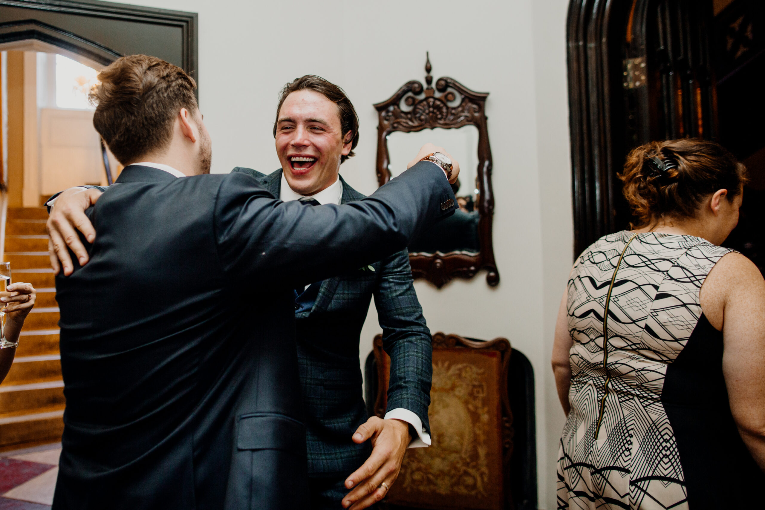 A person in a suit laughing