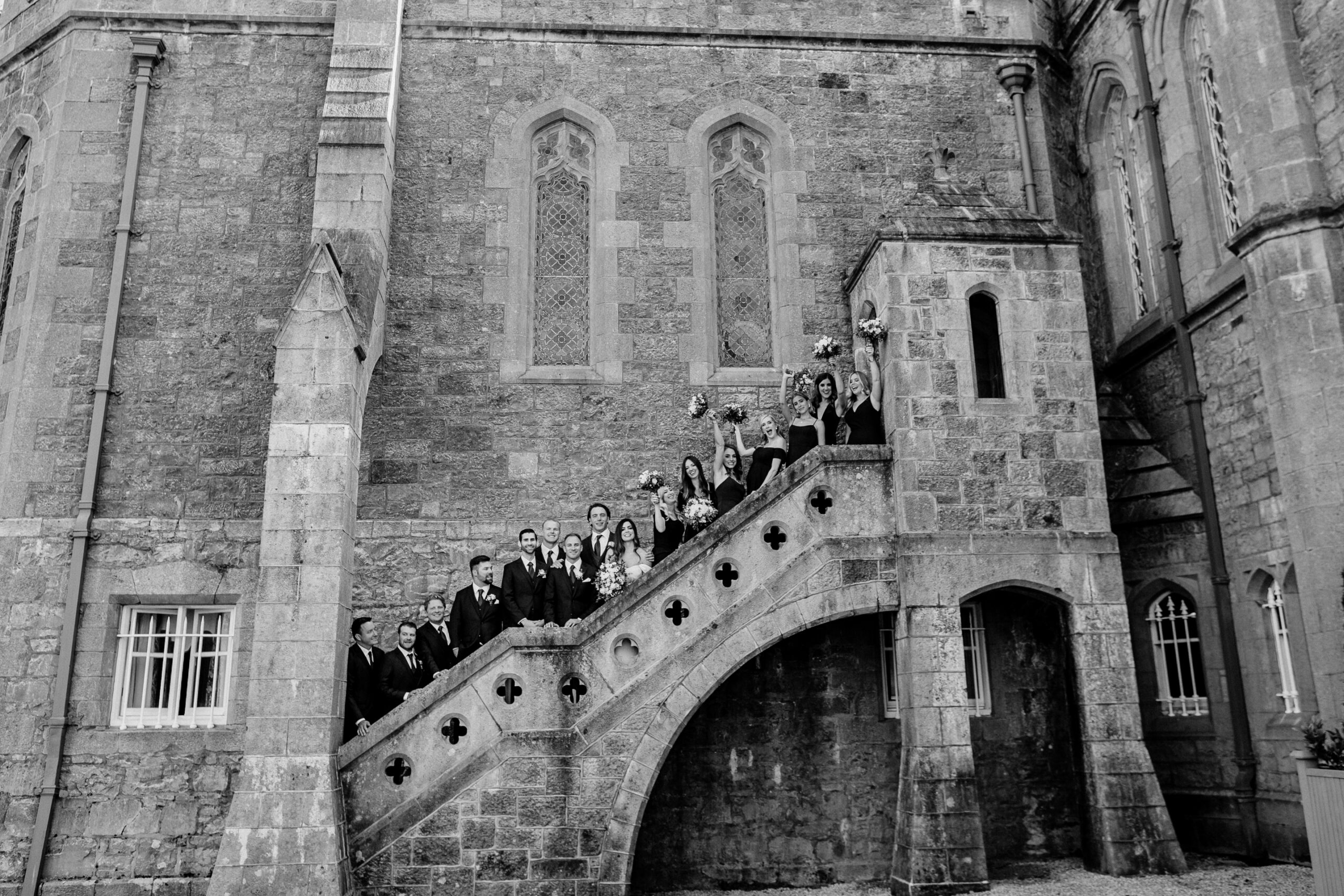 A group of people standing on a staircase in front of a building