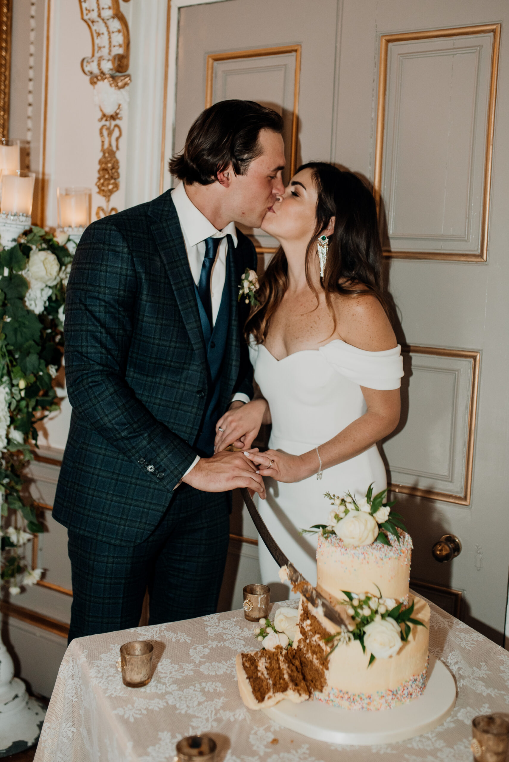 A bride and groom cutting a cake