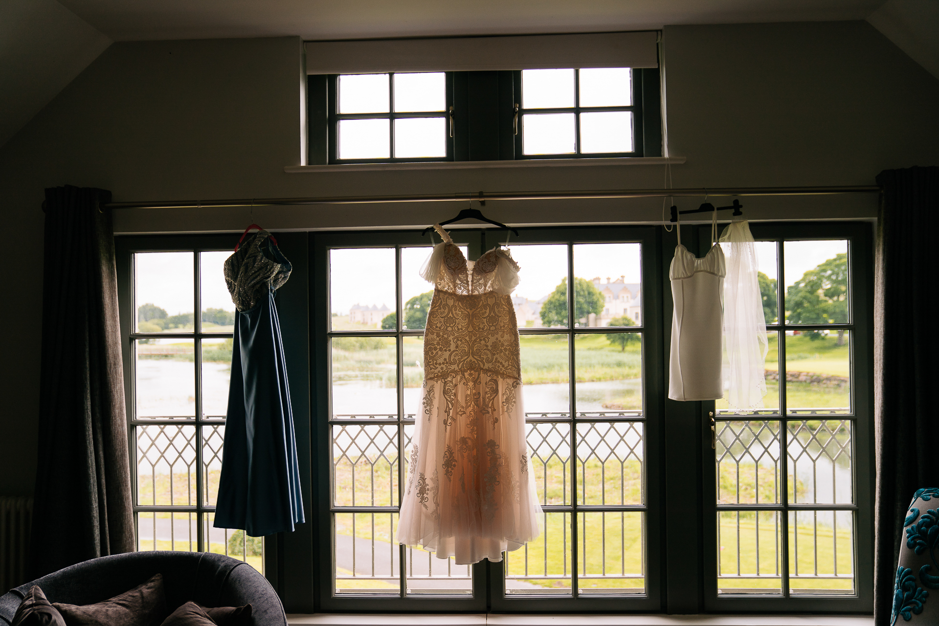 A cat in a dress on a window sill