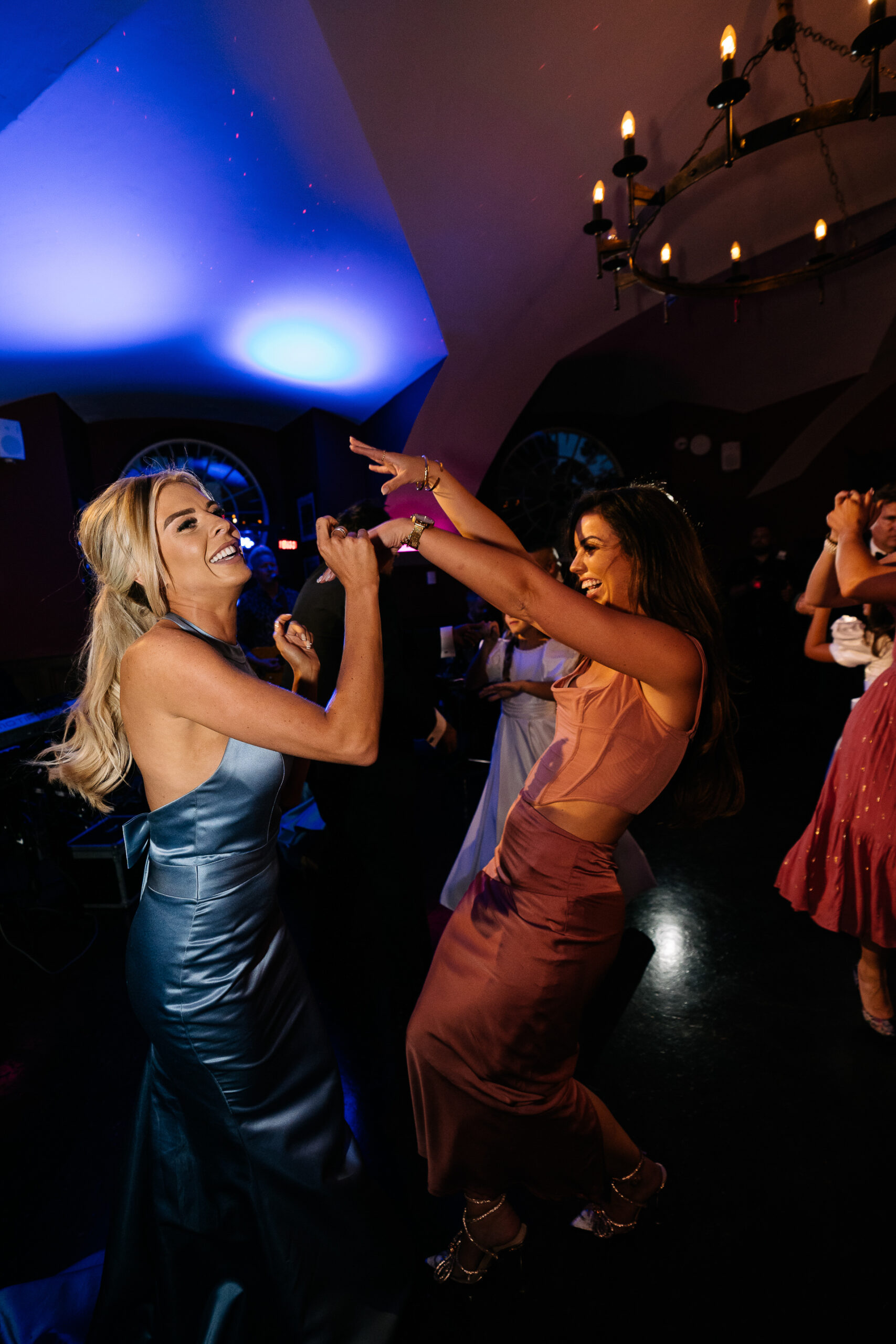 A person singing into a microphone next to another woman