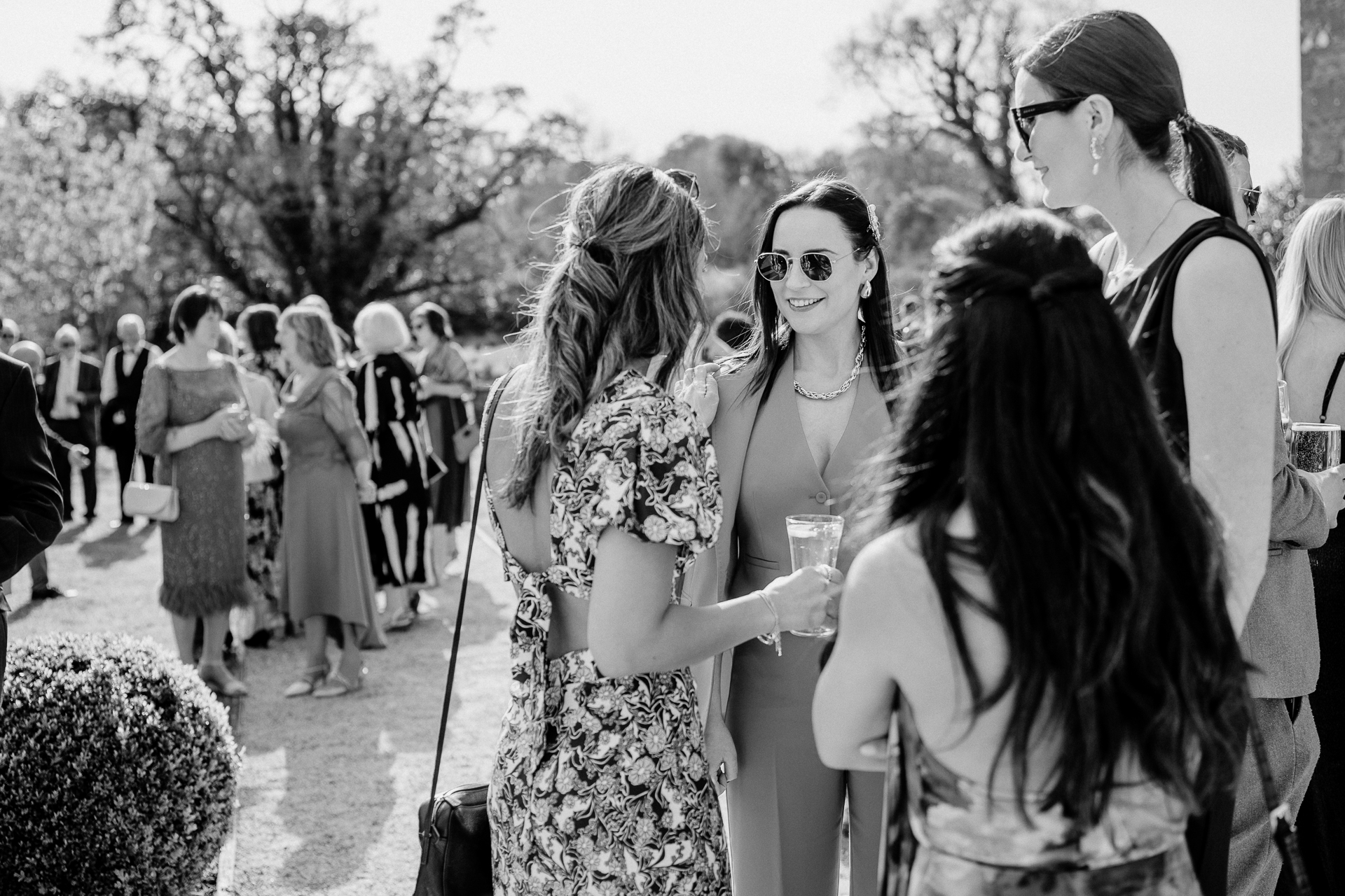 A group of women walking down a sidewalk