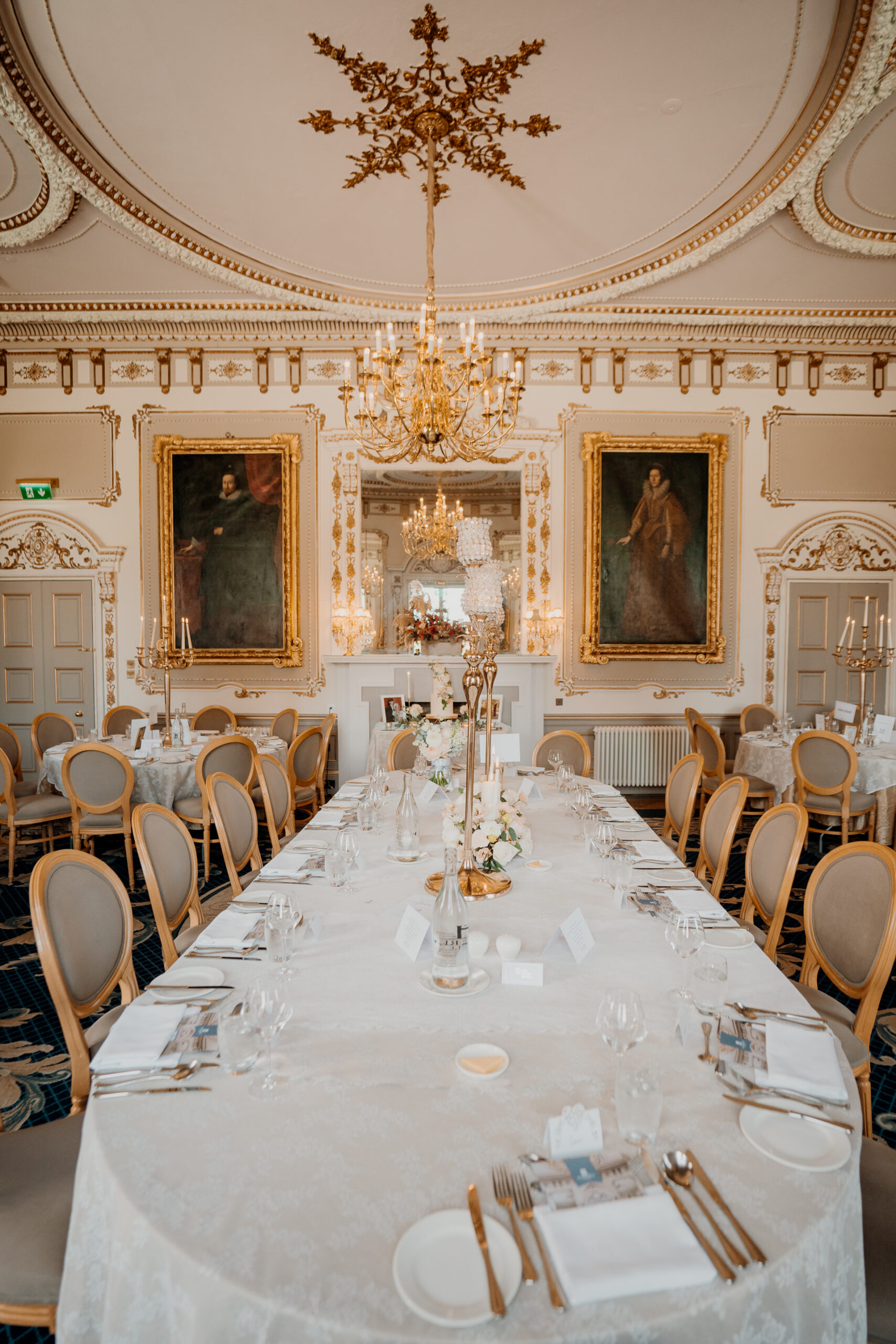 A dining room with a chandelier and a table set