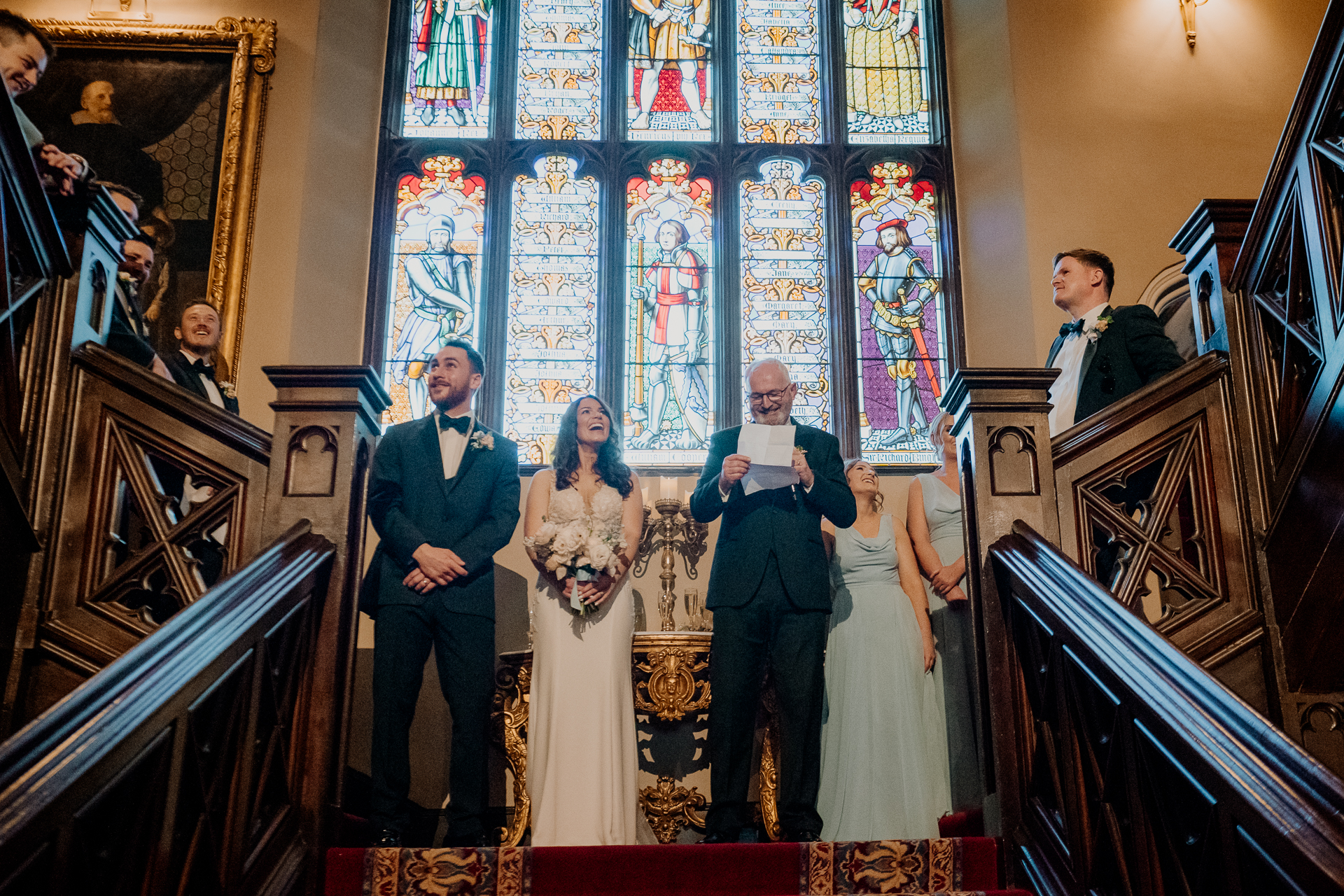 A bride and groom walking down the stairs