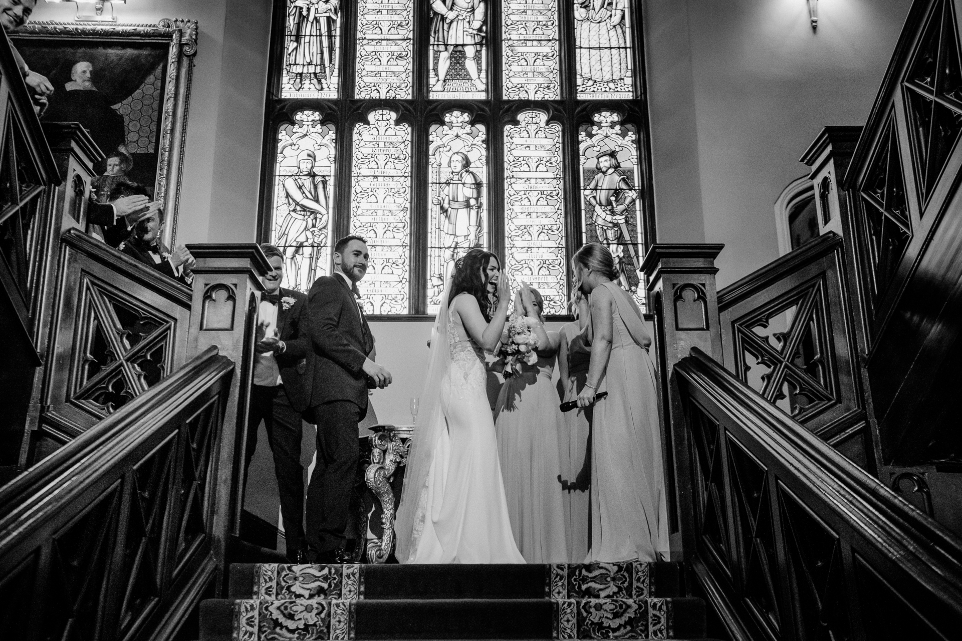 A bride and groom walking down the stairs