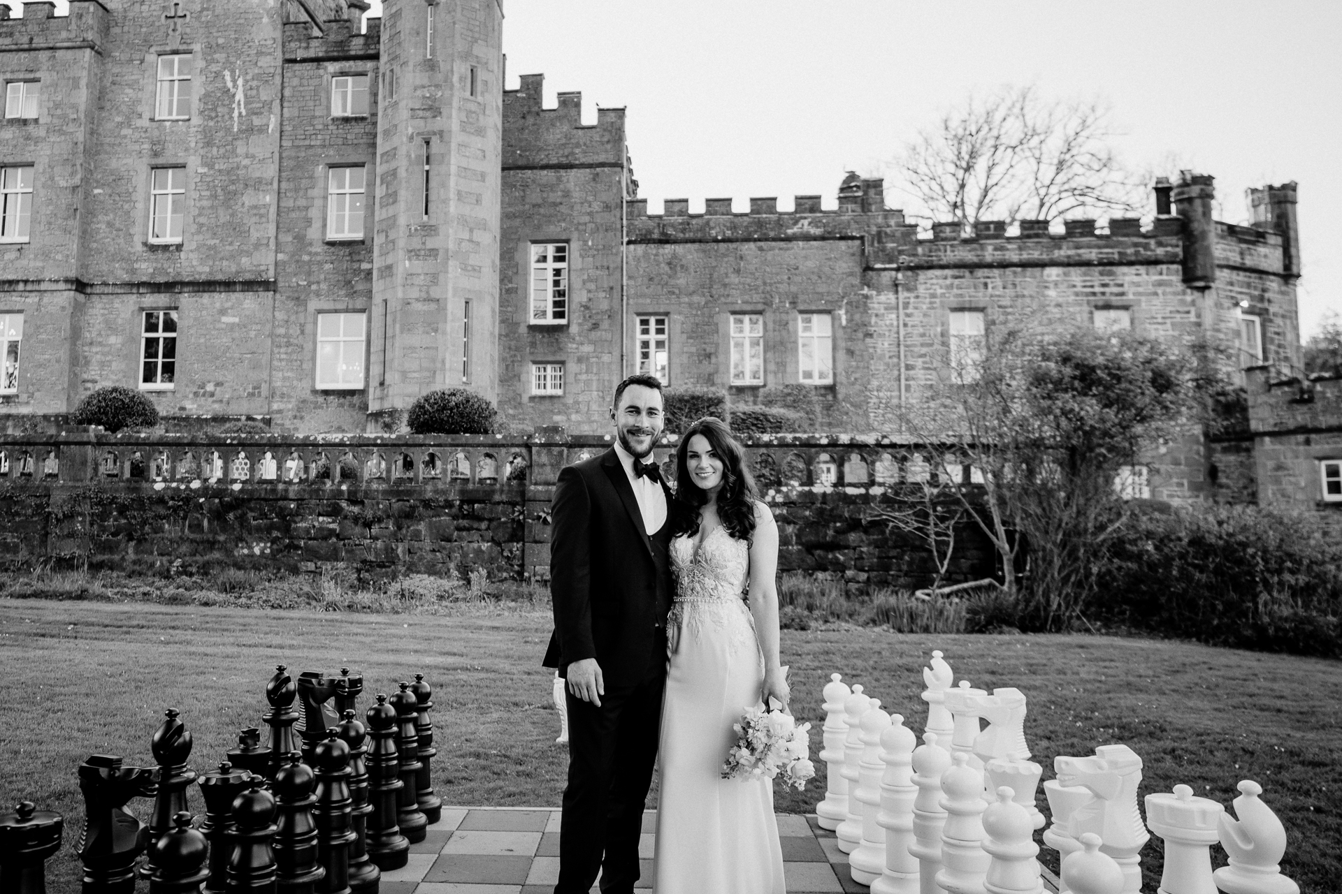 A man and woman posing for a picture in front of a building