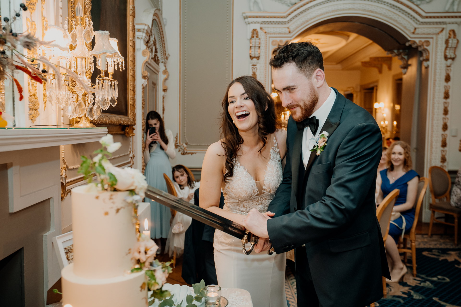 A bride and groom cutting a wedding cake