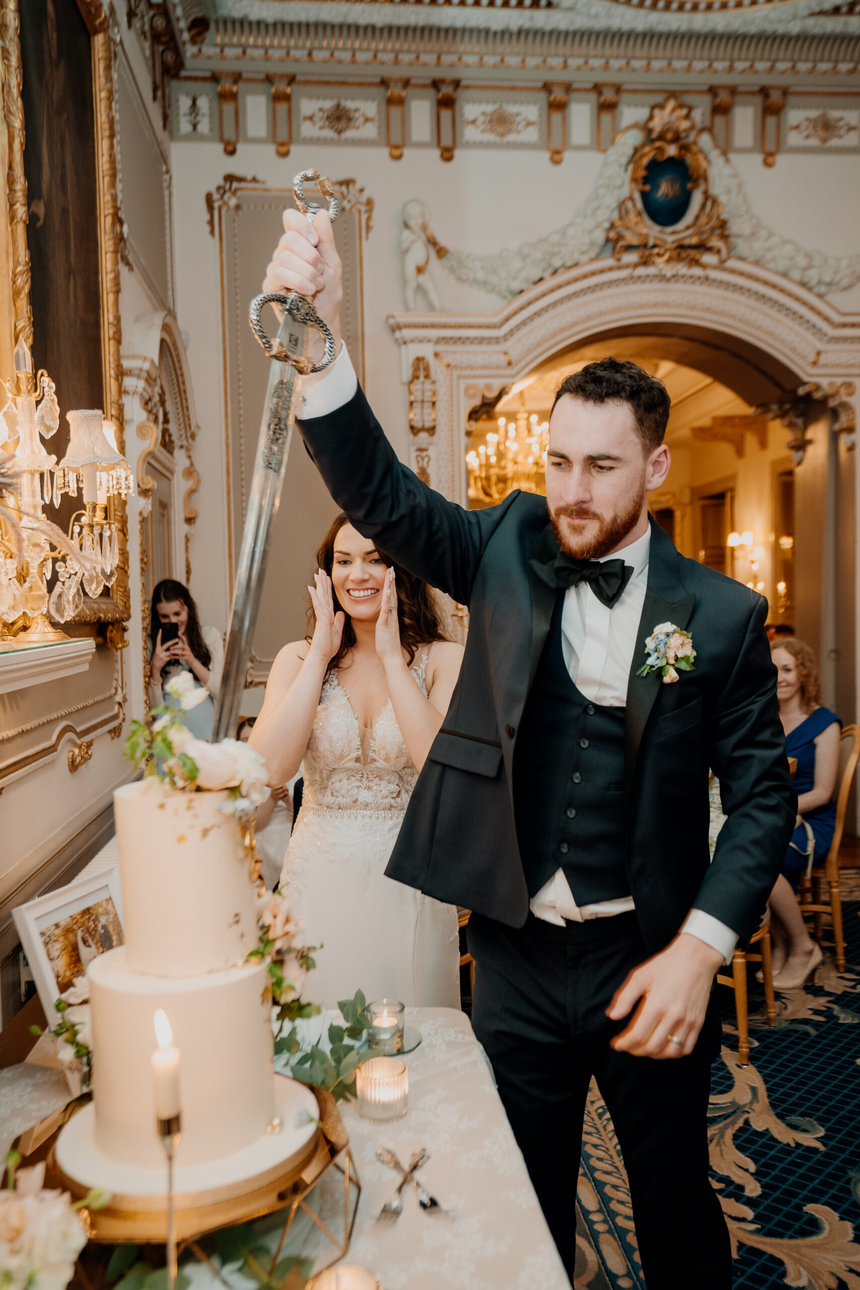 A bride and groom are cutting their wedding cake