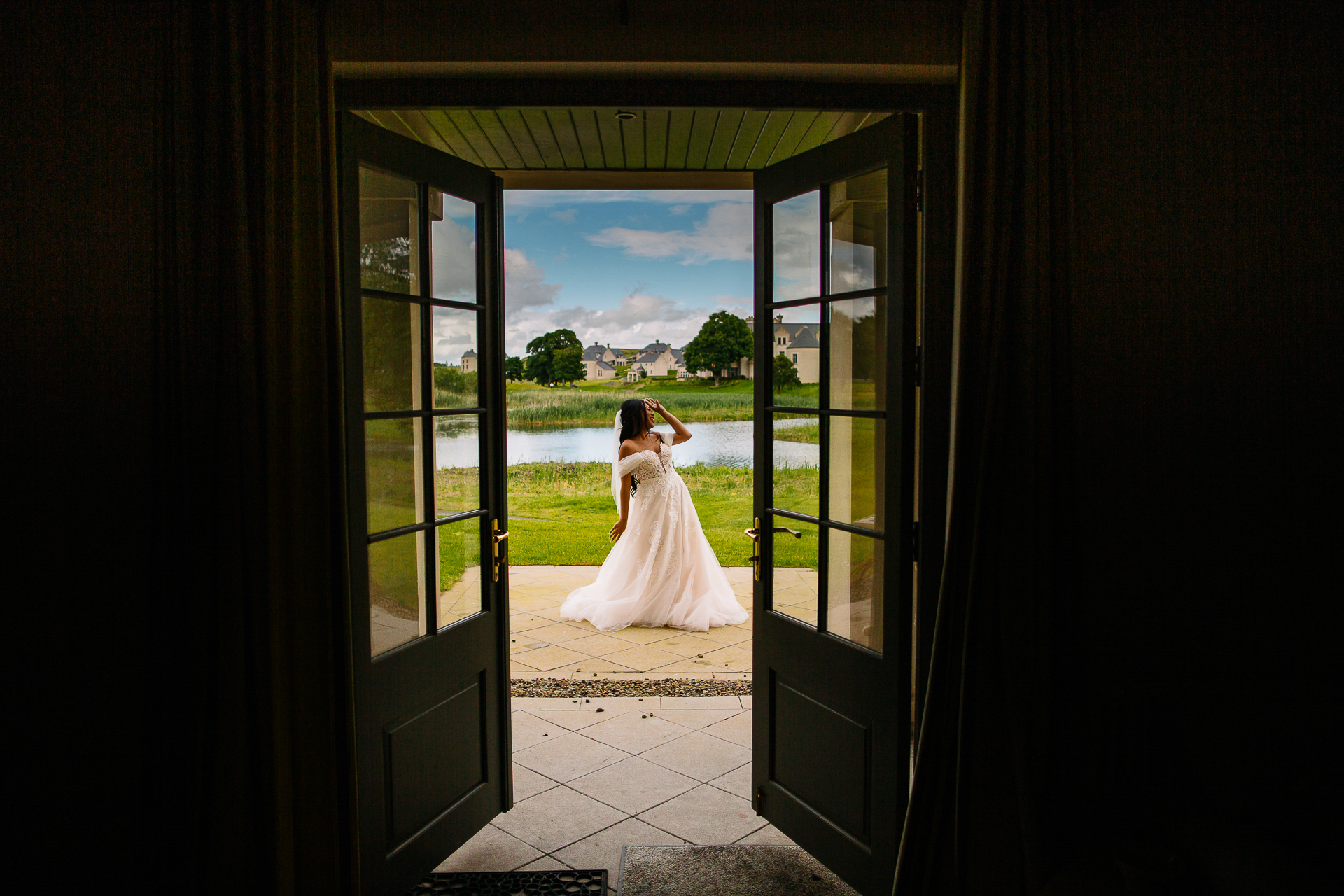 A bride and groom kissing in a doorway