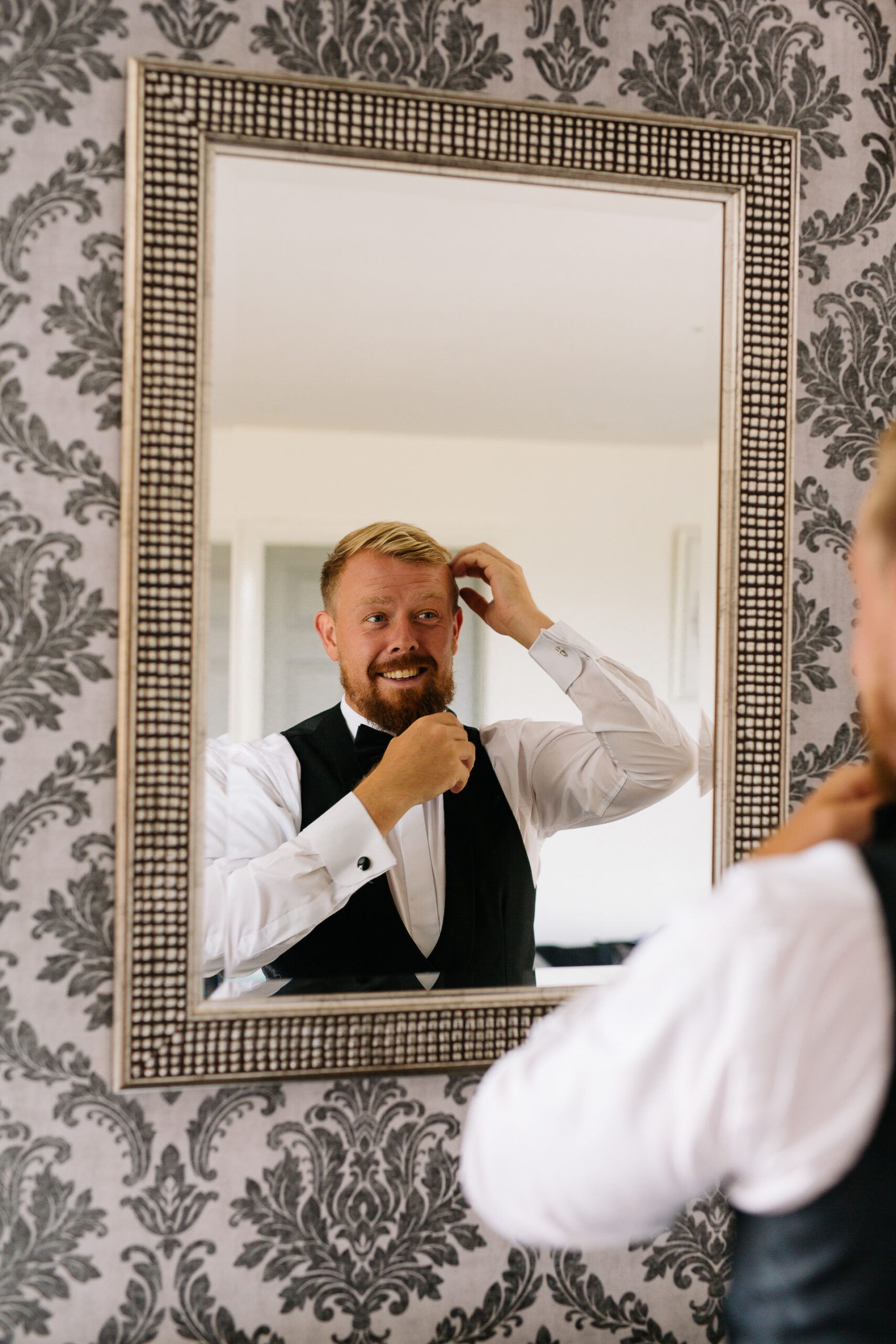 A man in a suit and tie in a mirror