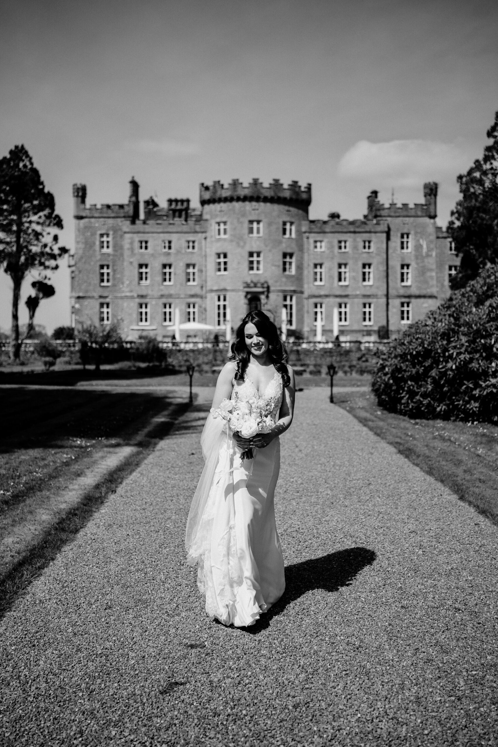 A person in a dress standing in front of a large building