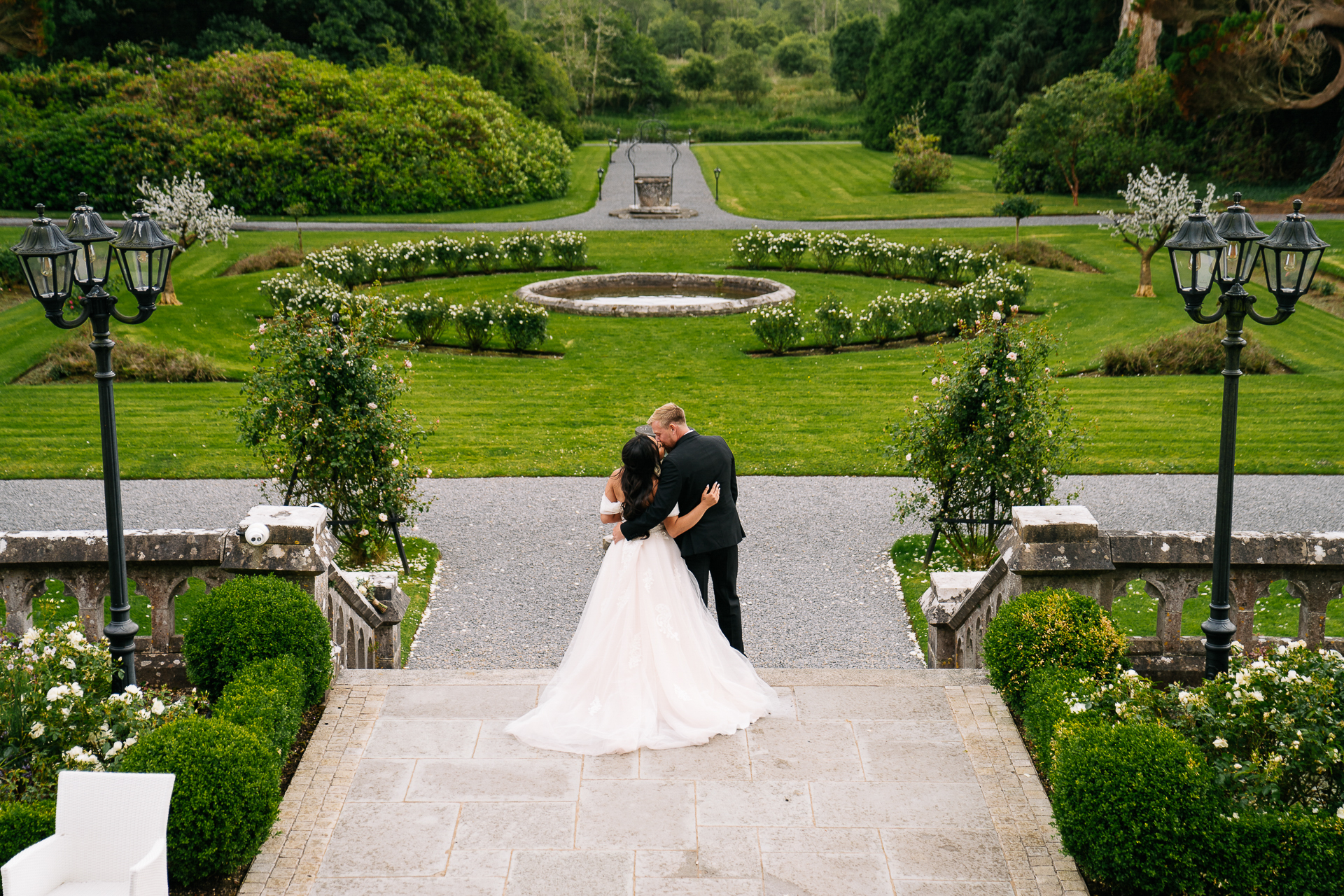 A man and woman kissing in a garden