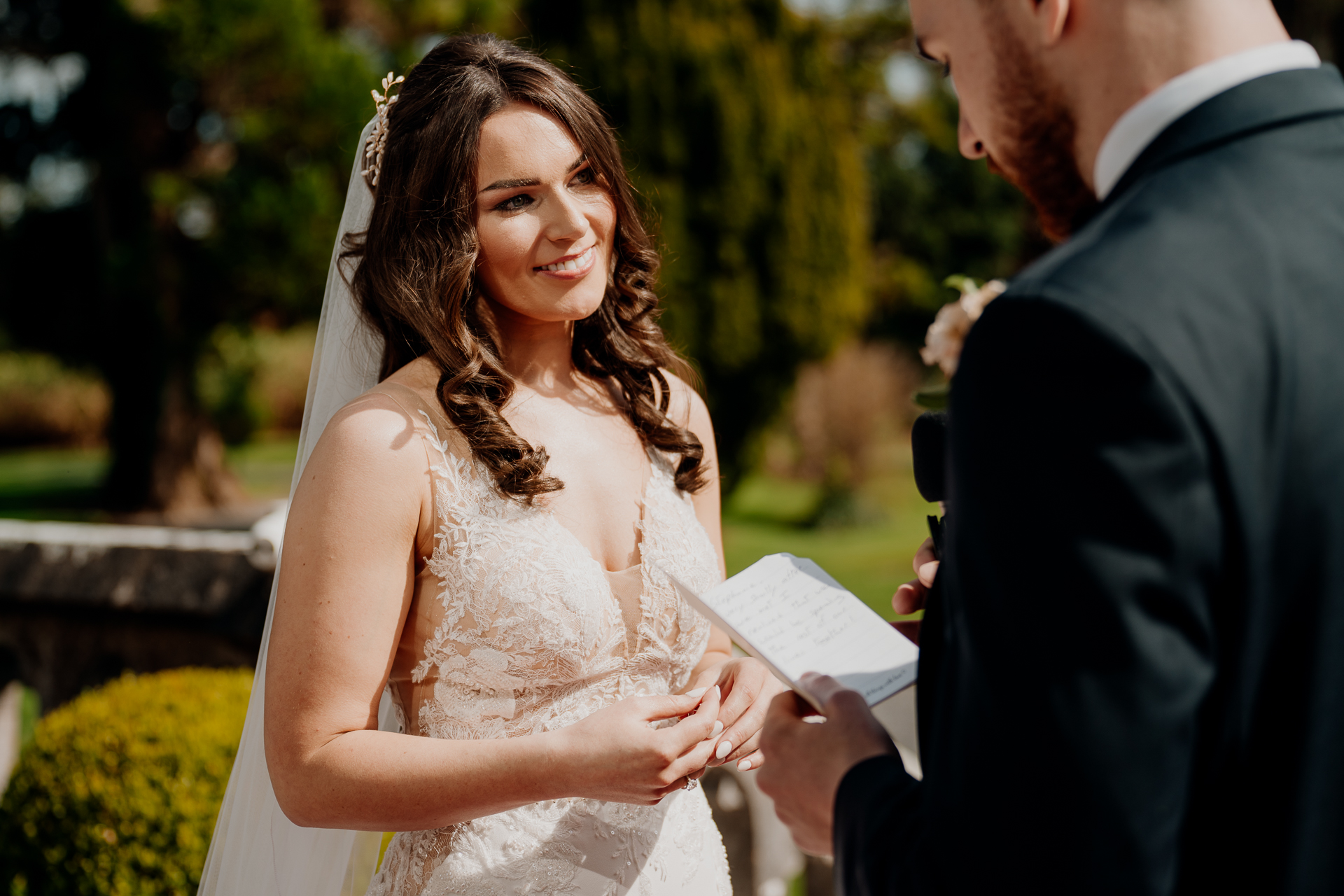 A person in a wedding dress holding a piece of paper