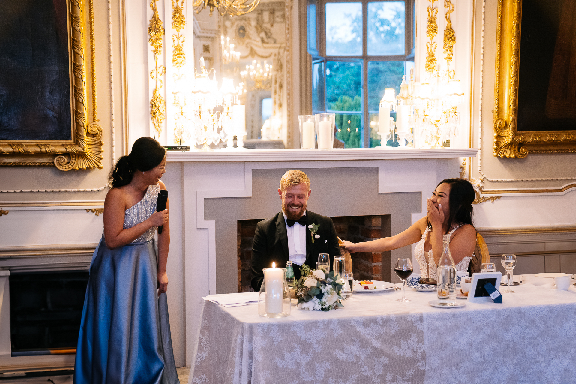 A group of people sitting at a table with a person in a suit