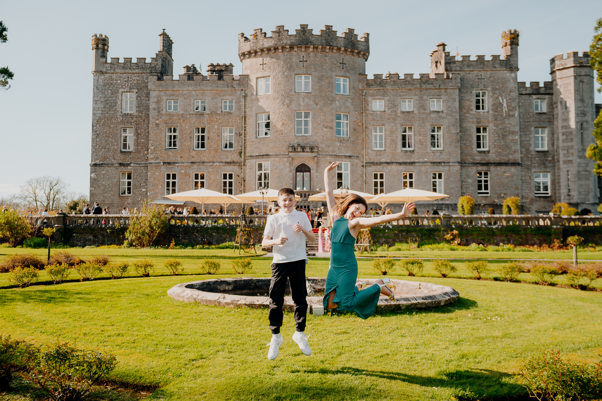 A man and woman posing in front of a large building