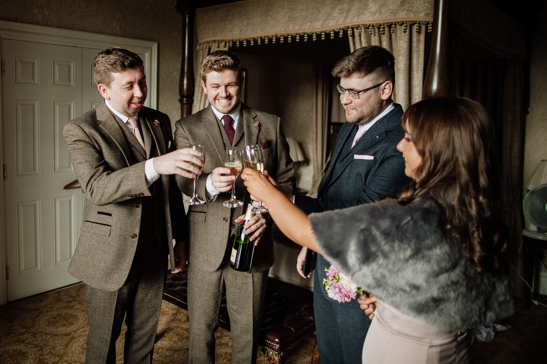 A group of people holding wine glasses