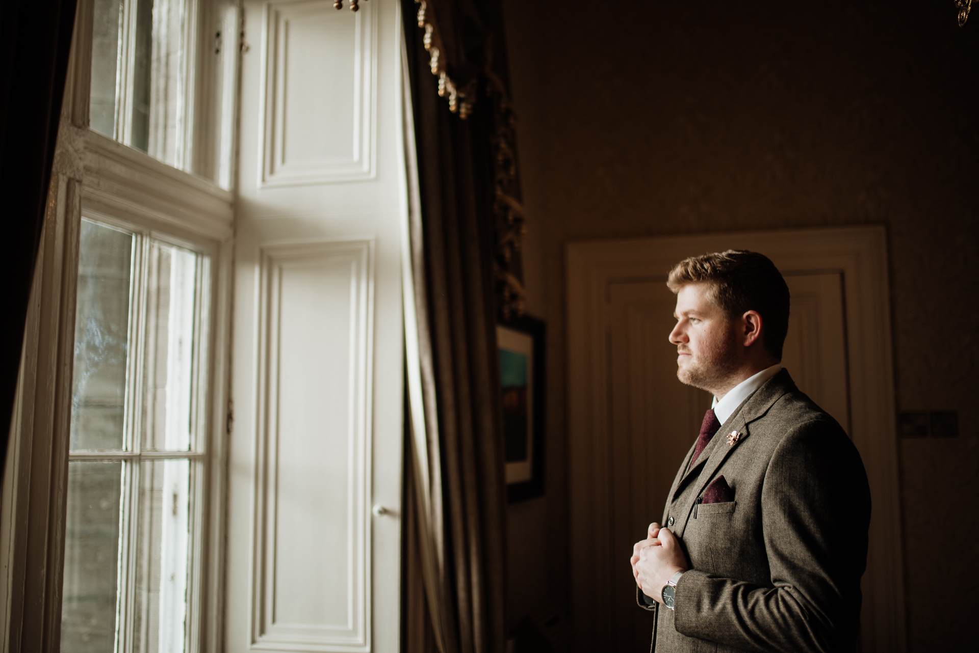 A man in a suit standing in a doorway