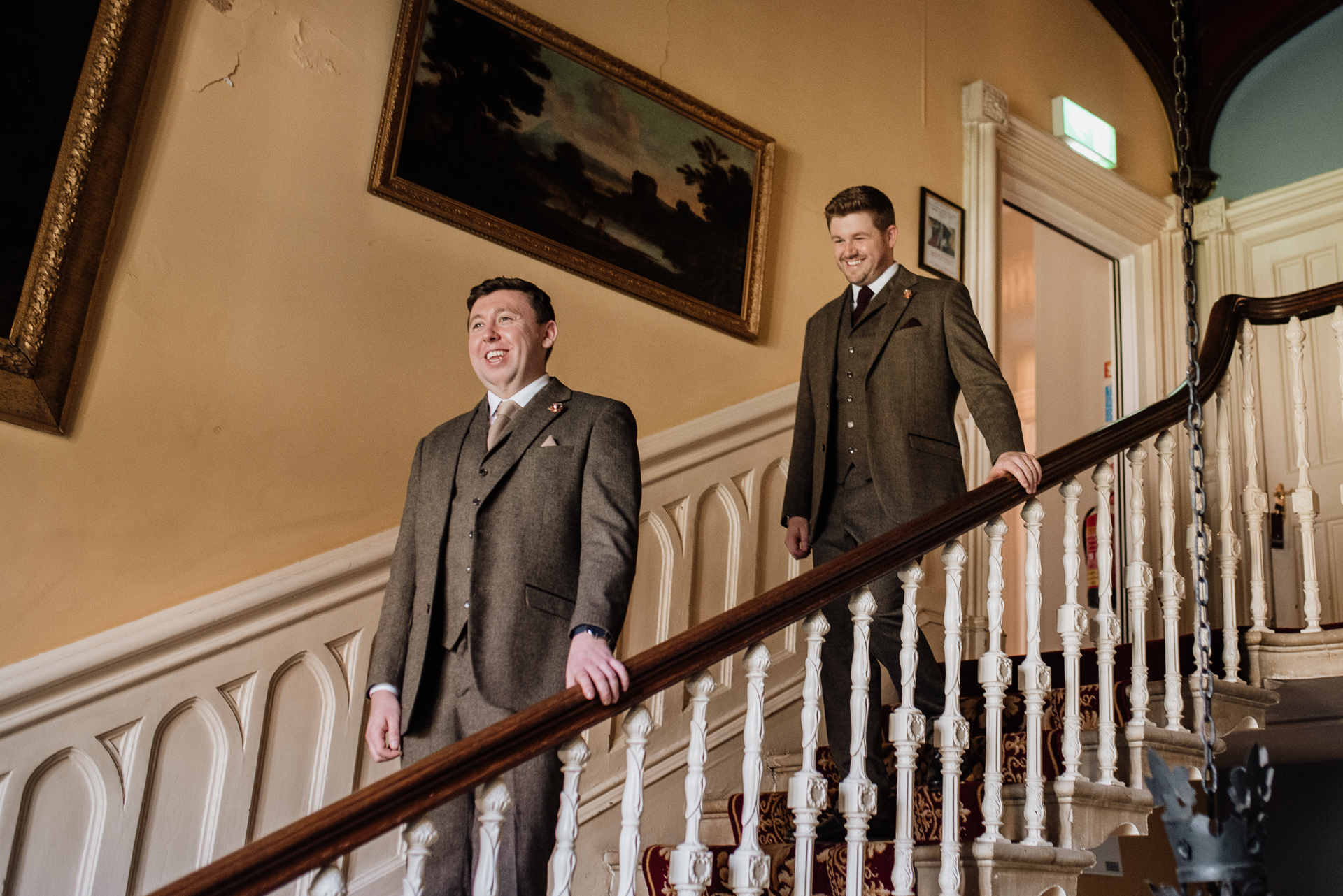 Two men in suits standing on a staircase