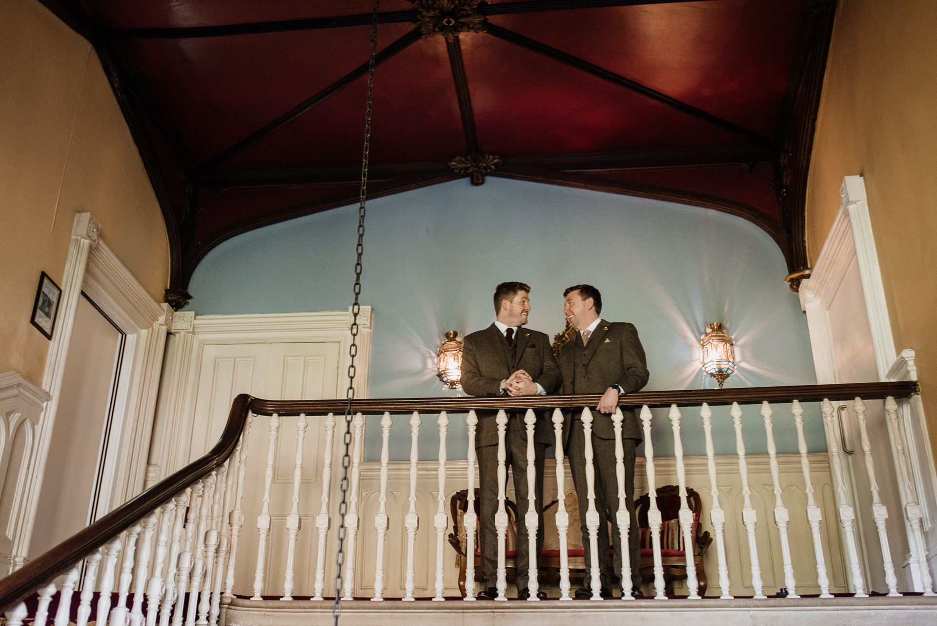 Two men standing on a balcony