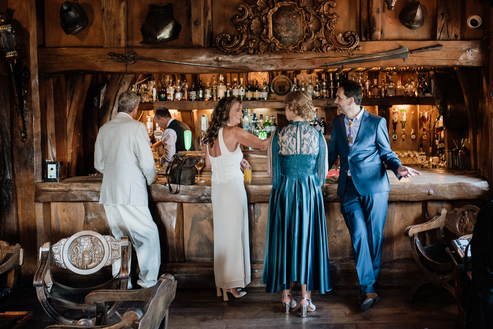 A group of people standing in a bar