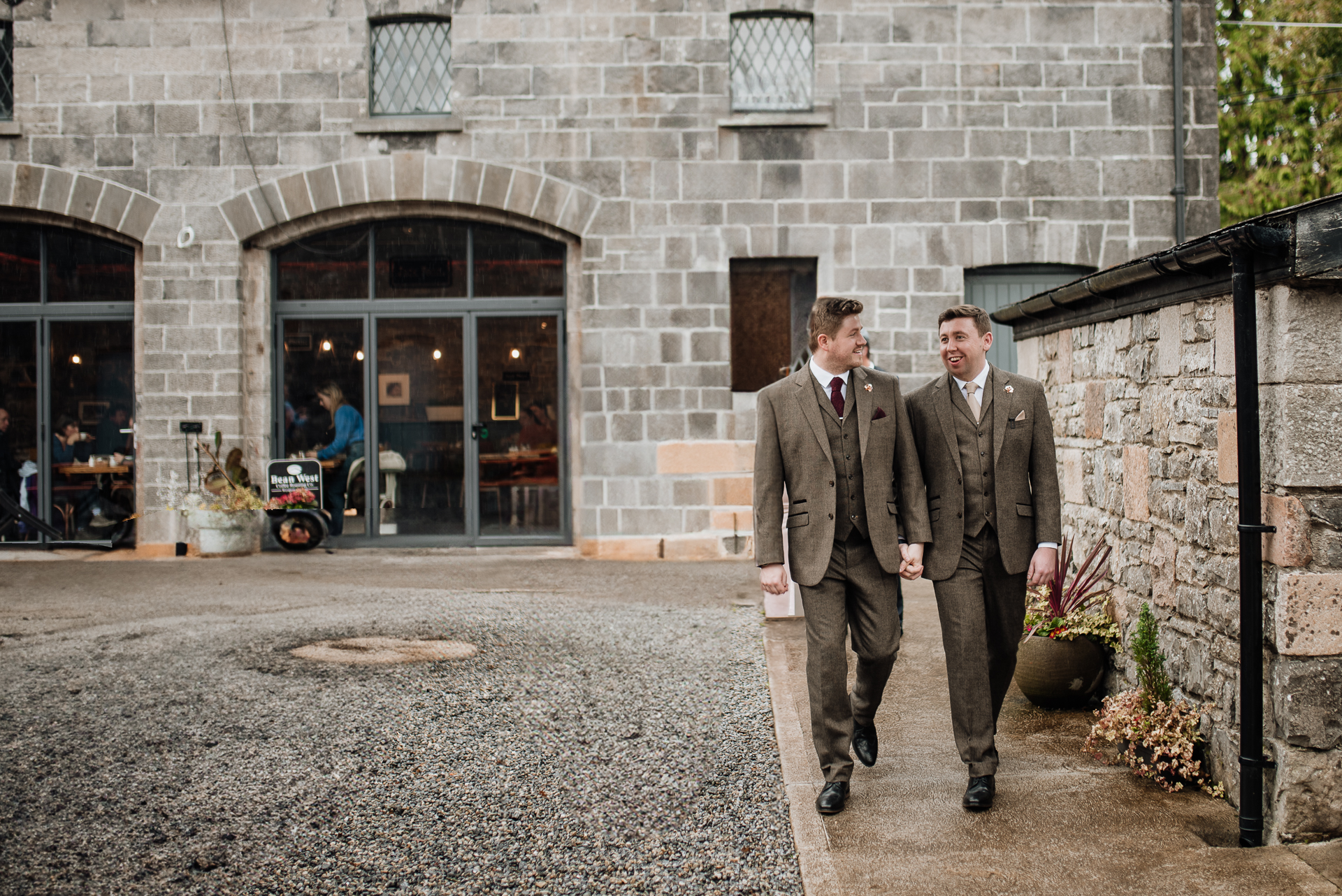 Two men in suits walking outside a building