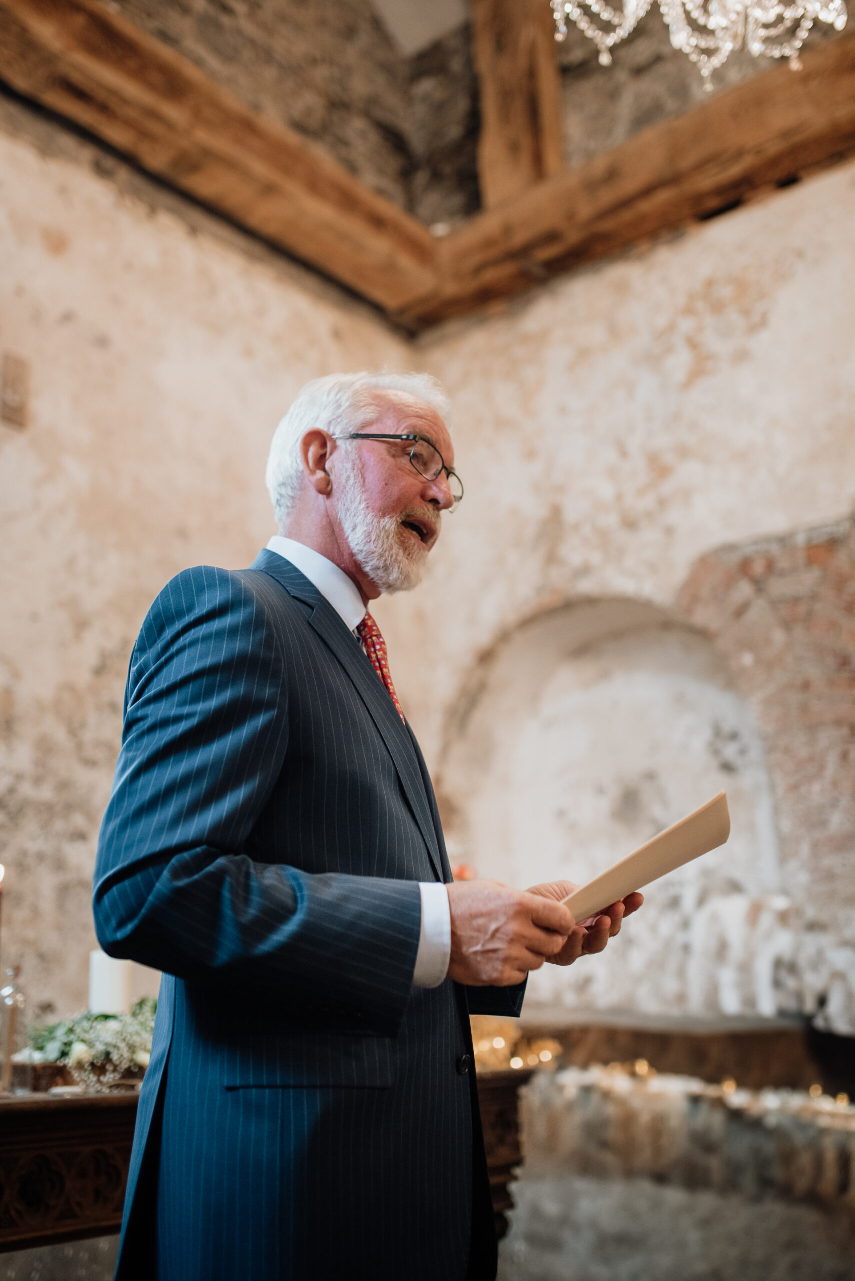 A man in a suit holding a book