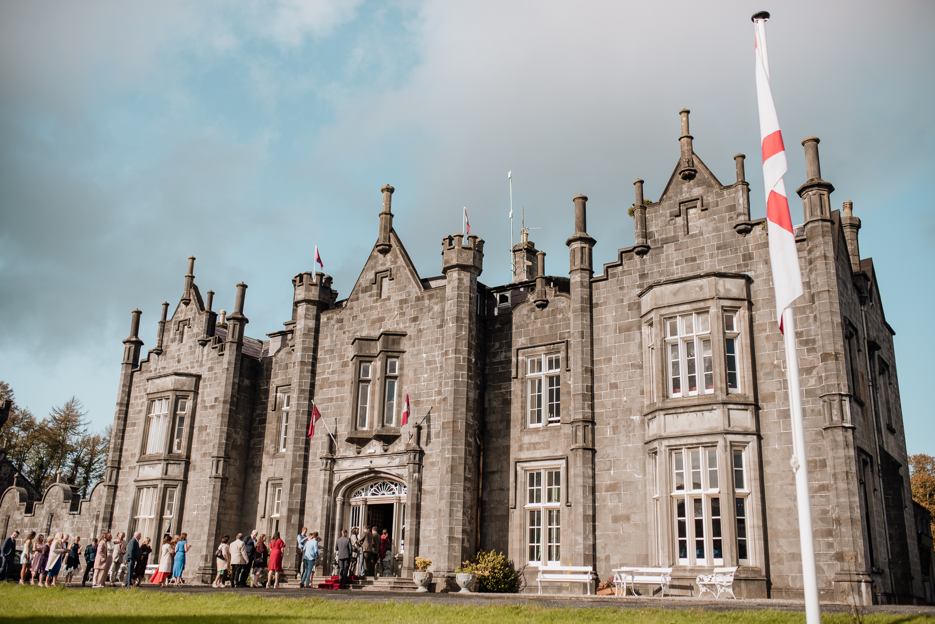 A large stone building with flags