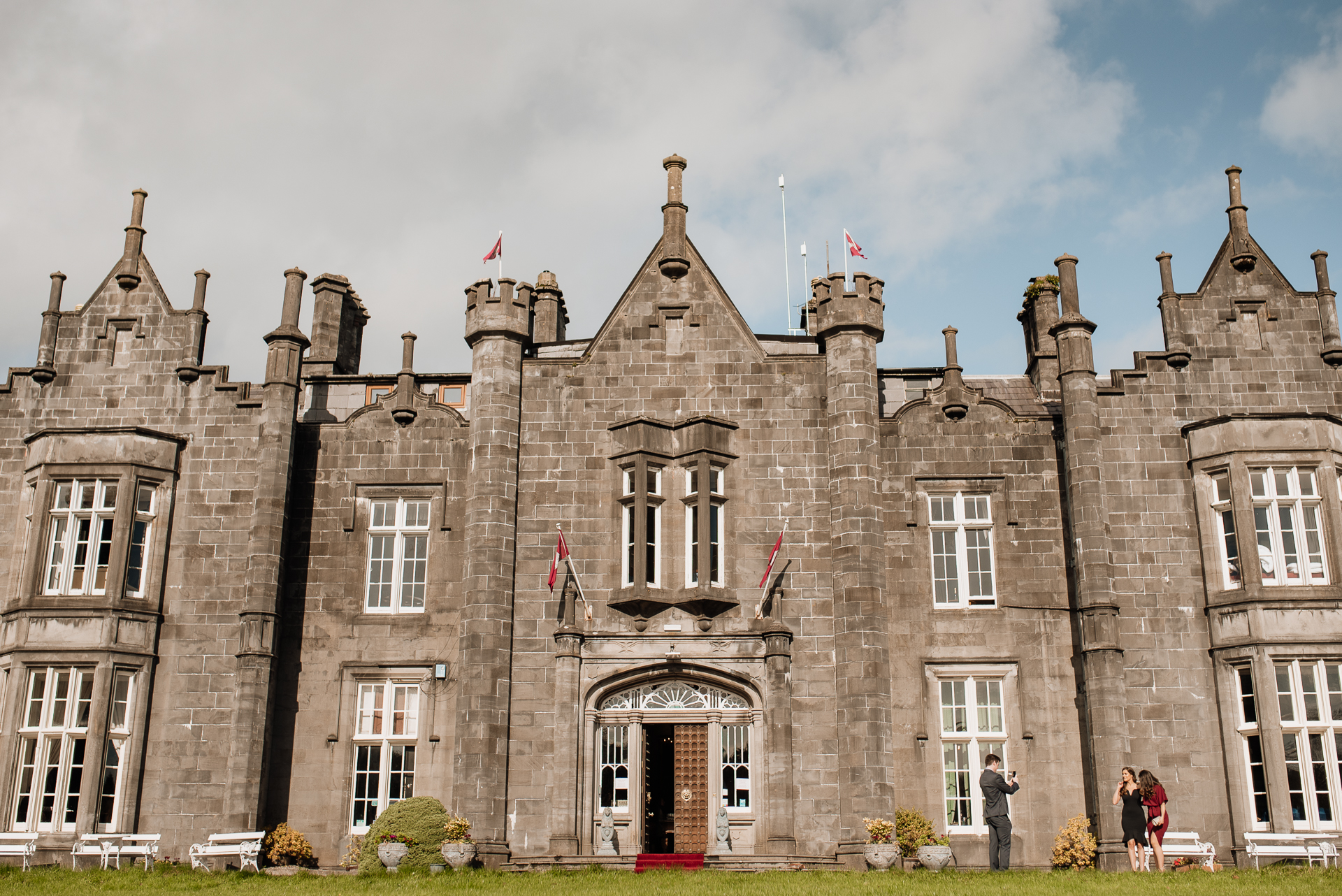 A stone building with flags on the roof