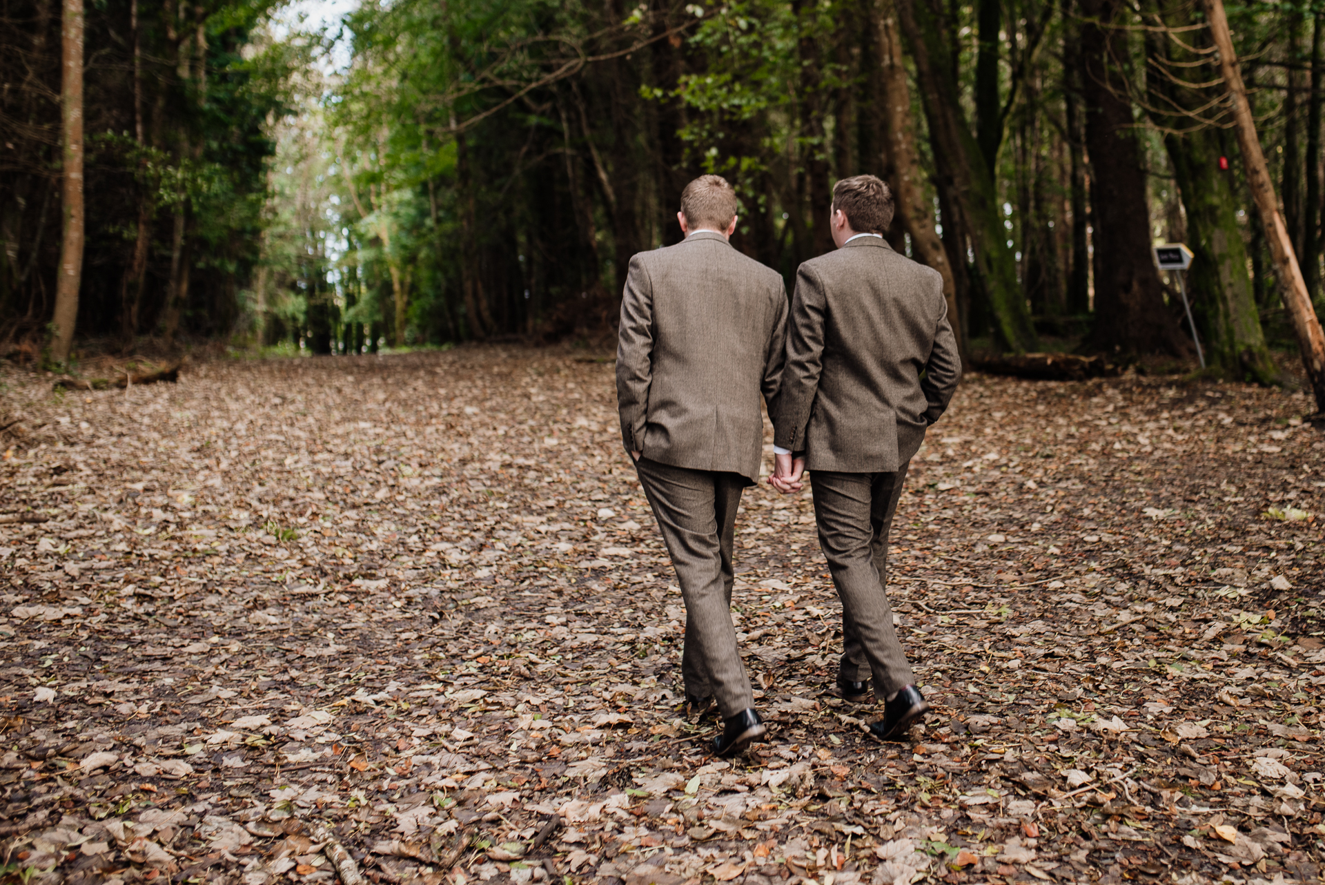 Two men walking on a path in the woods