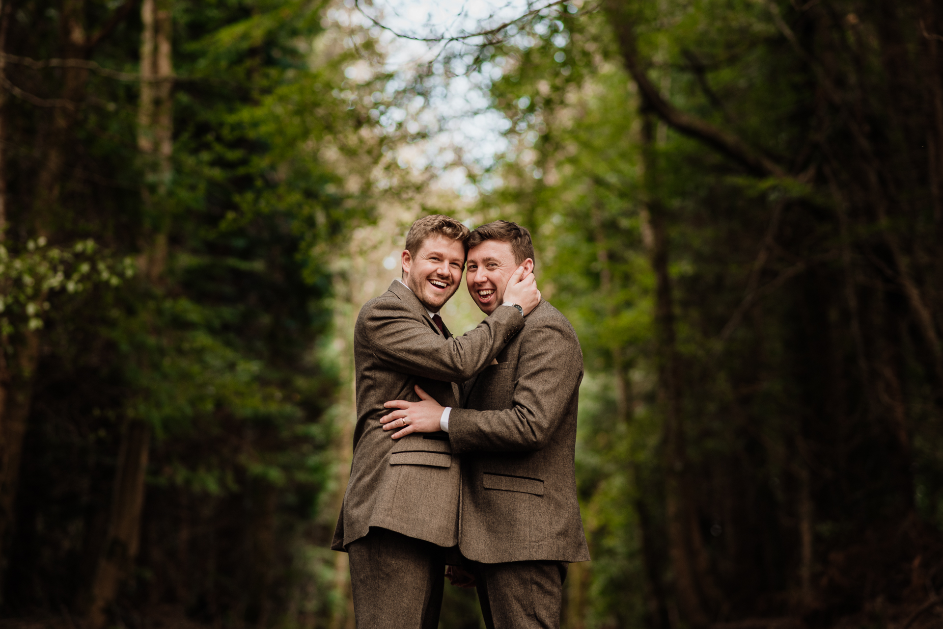 A person holding another man in the woods