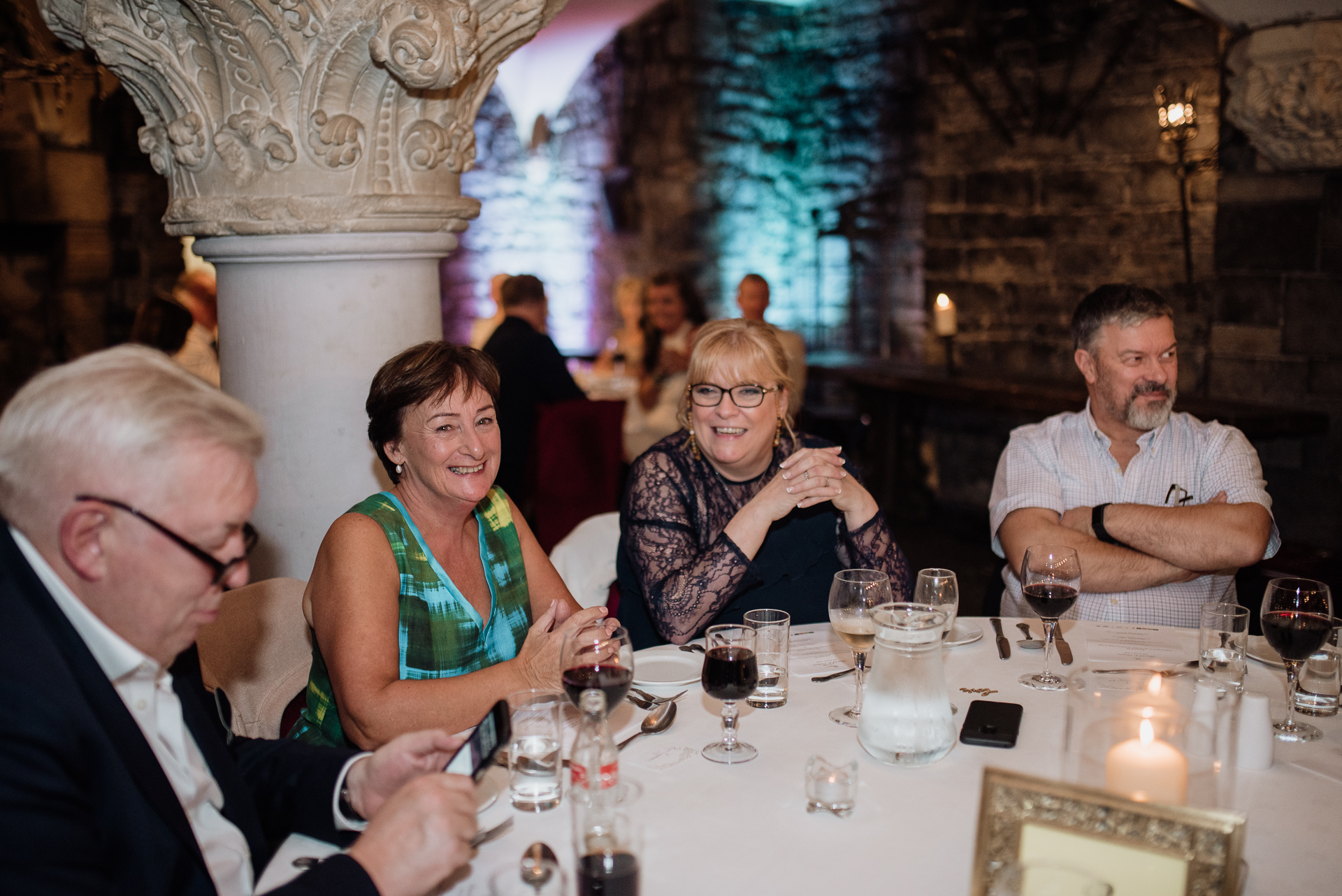 A group of people sitting at a table with wine glasses