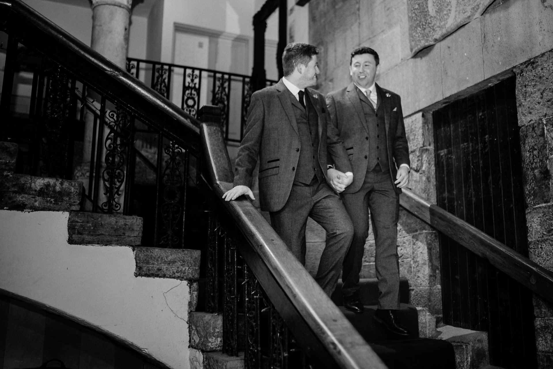 A group of men walking up a flight of stairs